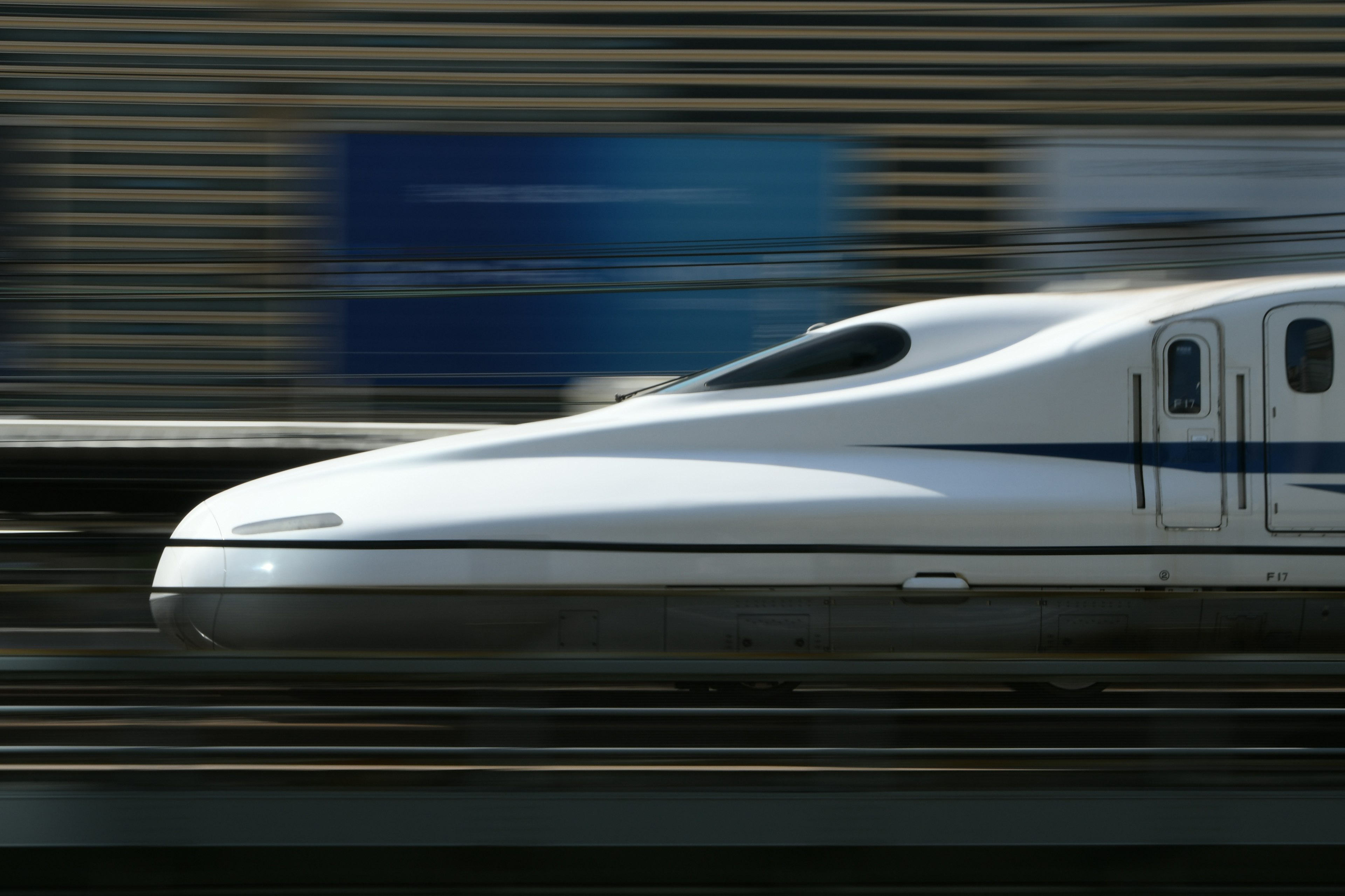 Shinkansen high-speed train in motion with streamlined design