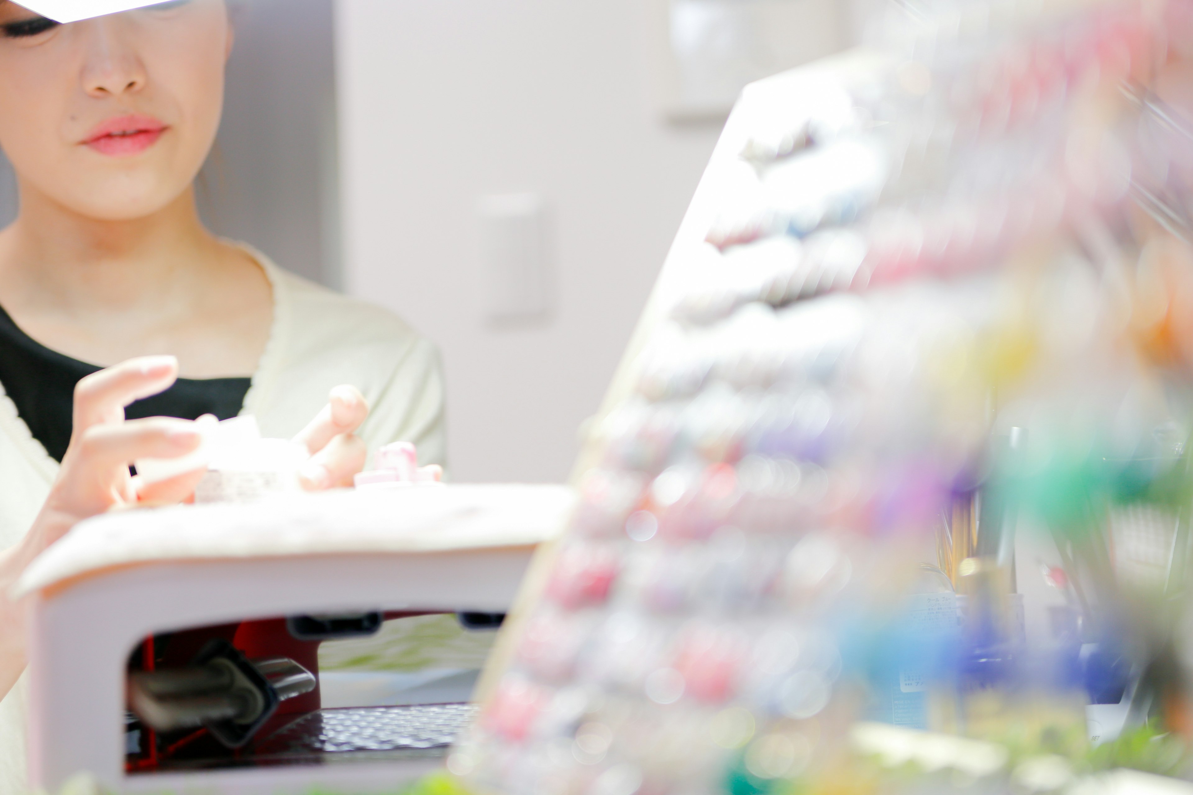 A woman handling colorful nail polish in a beauty salon