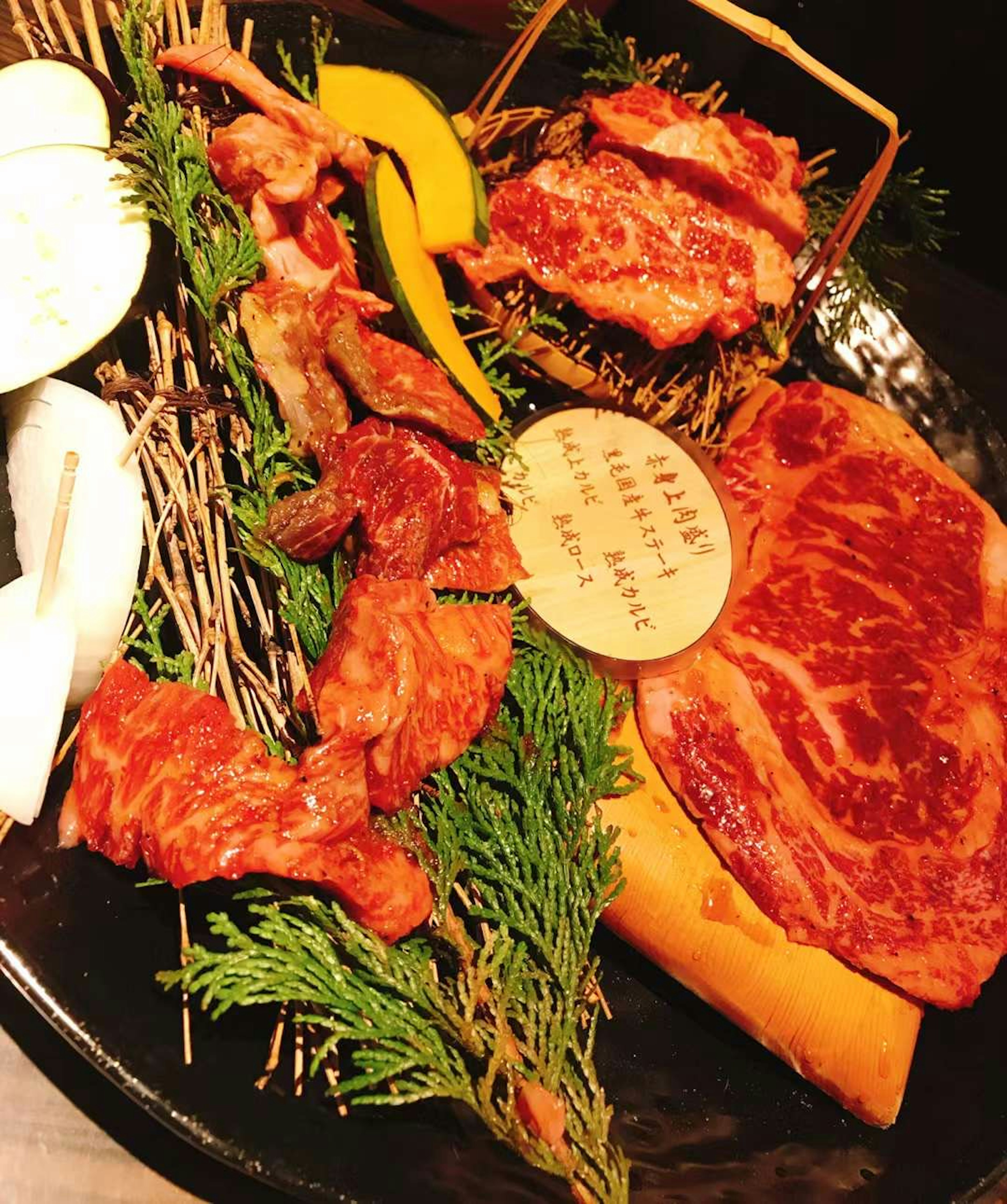 A beautifully arranged platter of meats and herbs