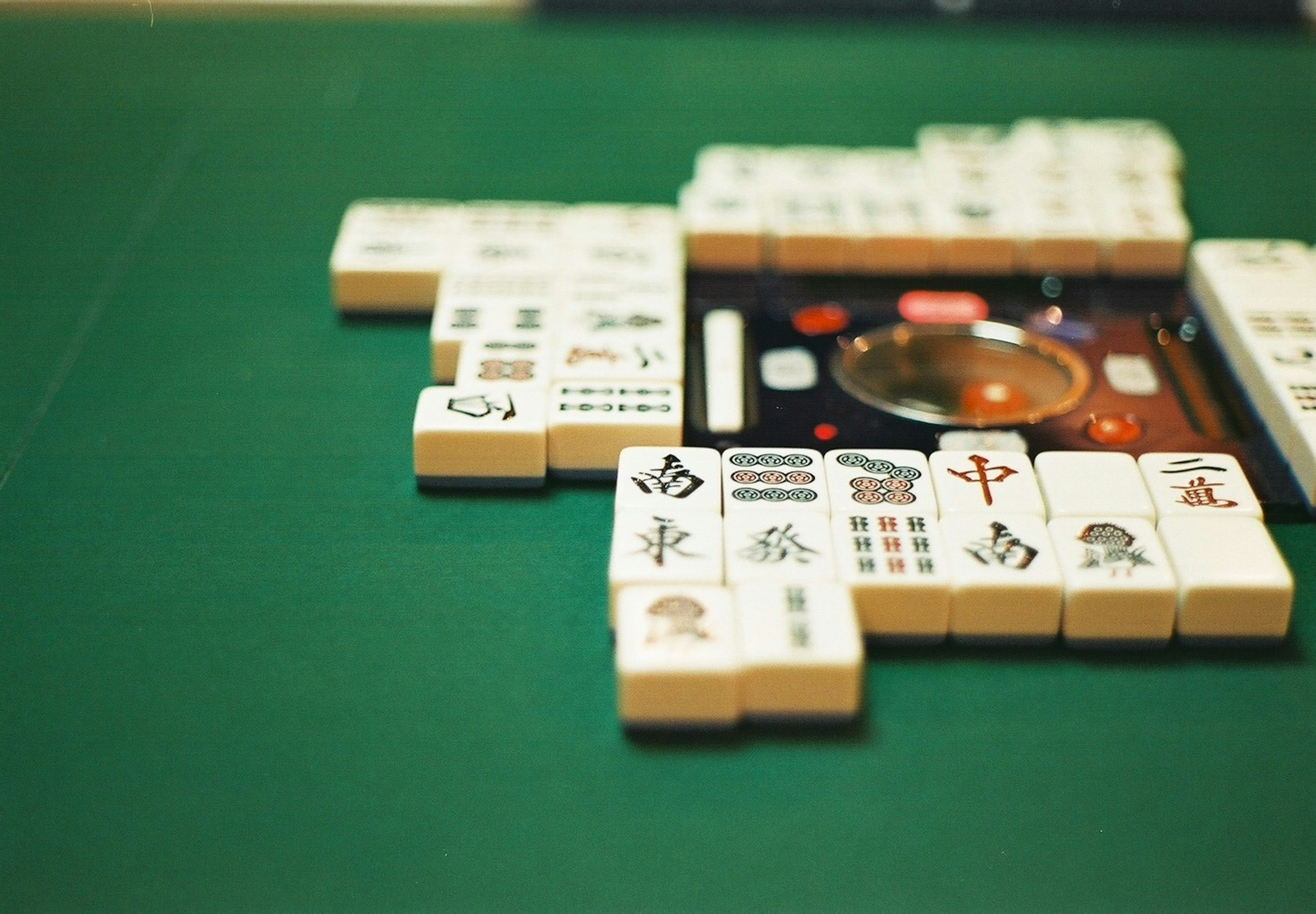 Close-up of a Mahjong game table with tiles arranged