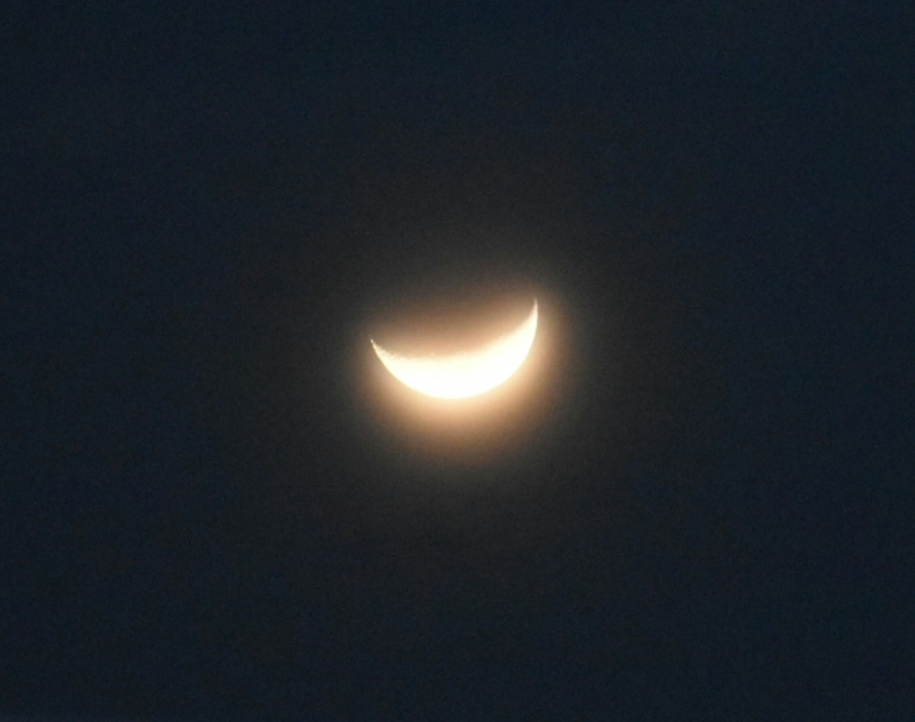 Smiling crescent moon in the night sky