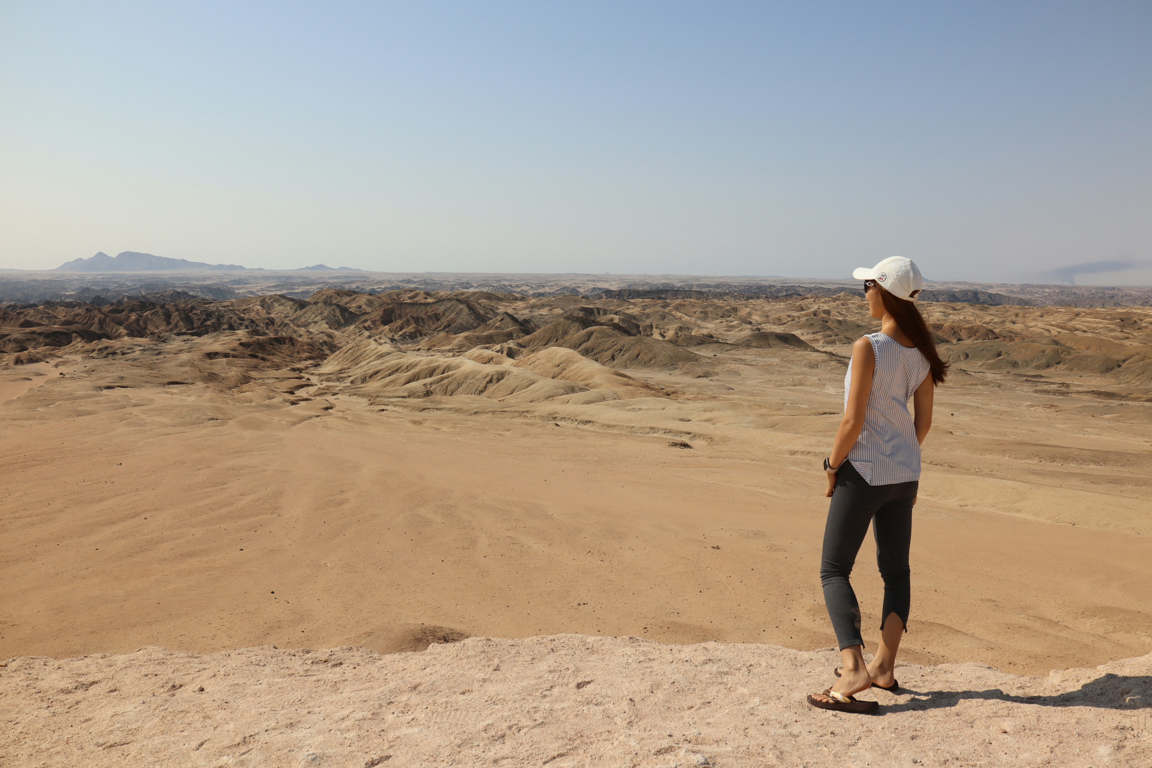 Woman looking at vast desert landscape