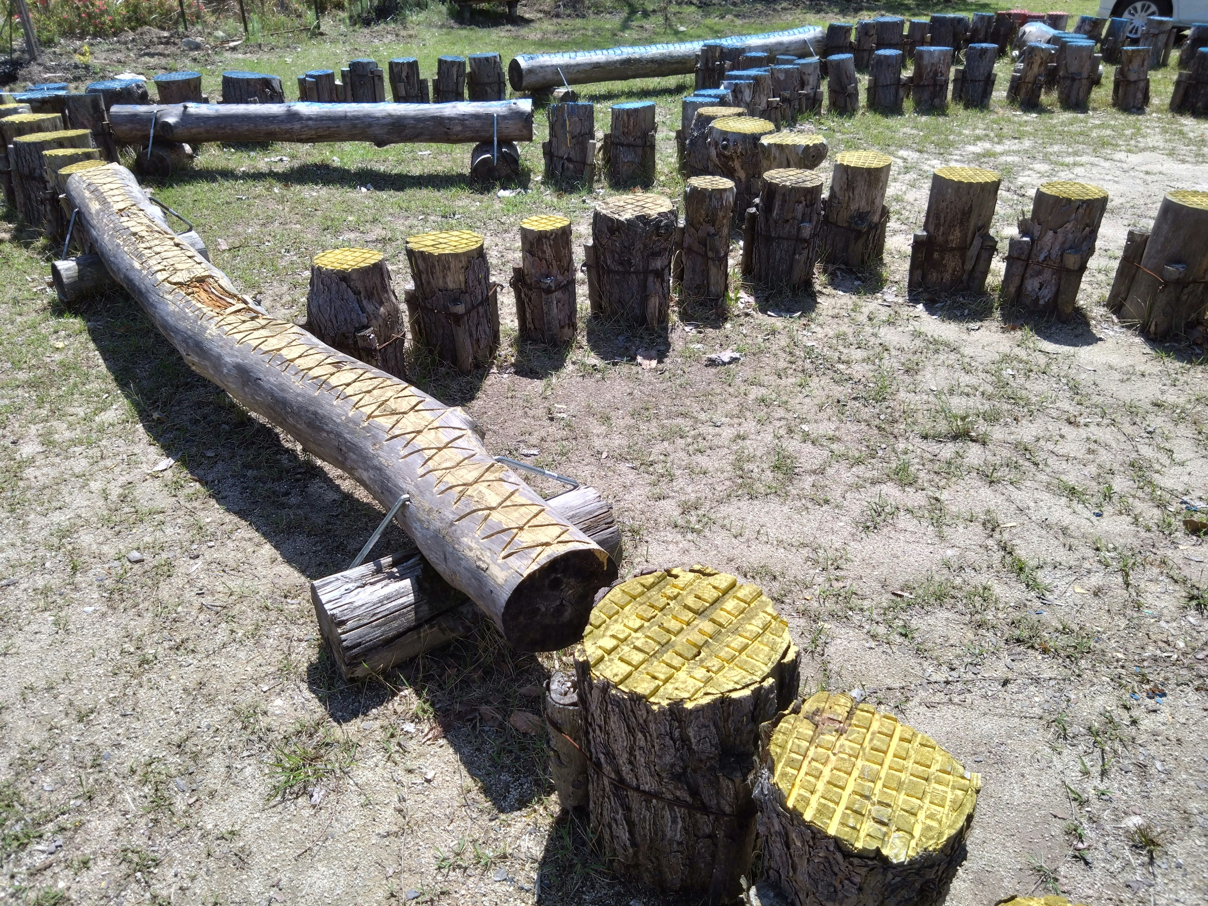 Arrangement of wooden logs and stools in a playground