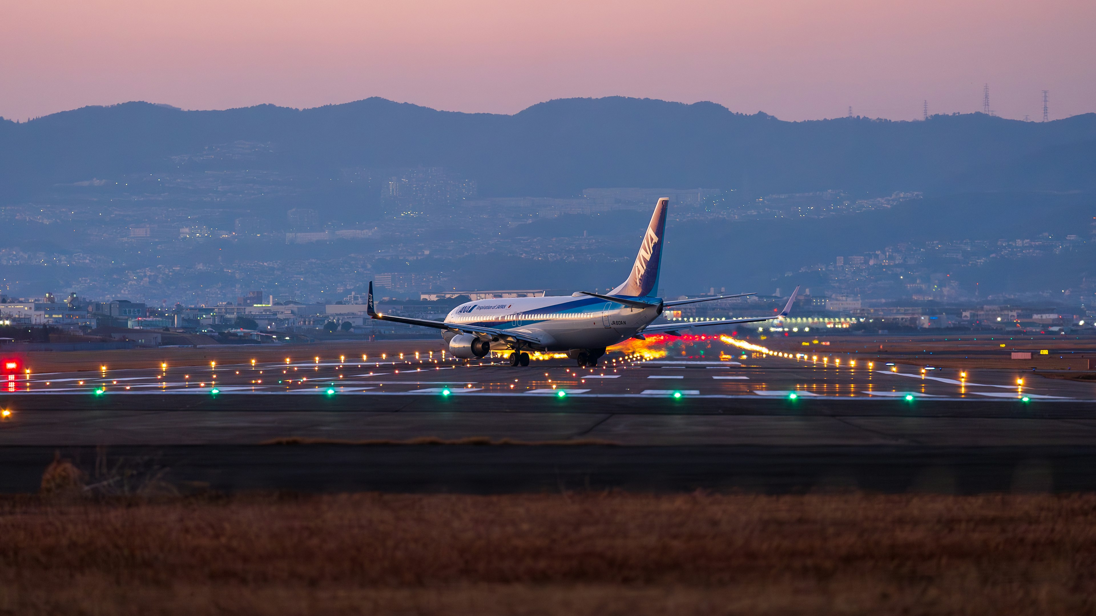 Airplane landing on the runway during twilight