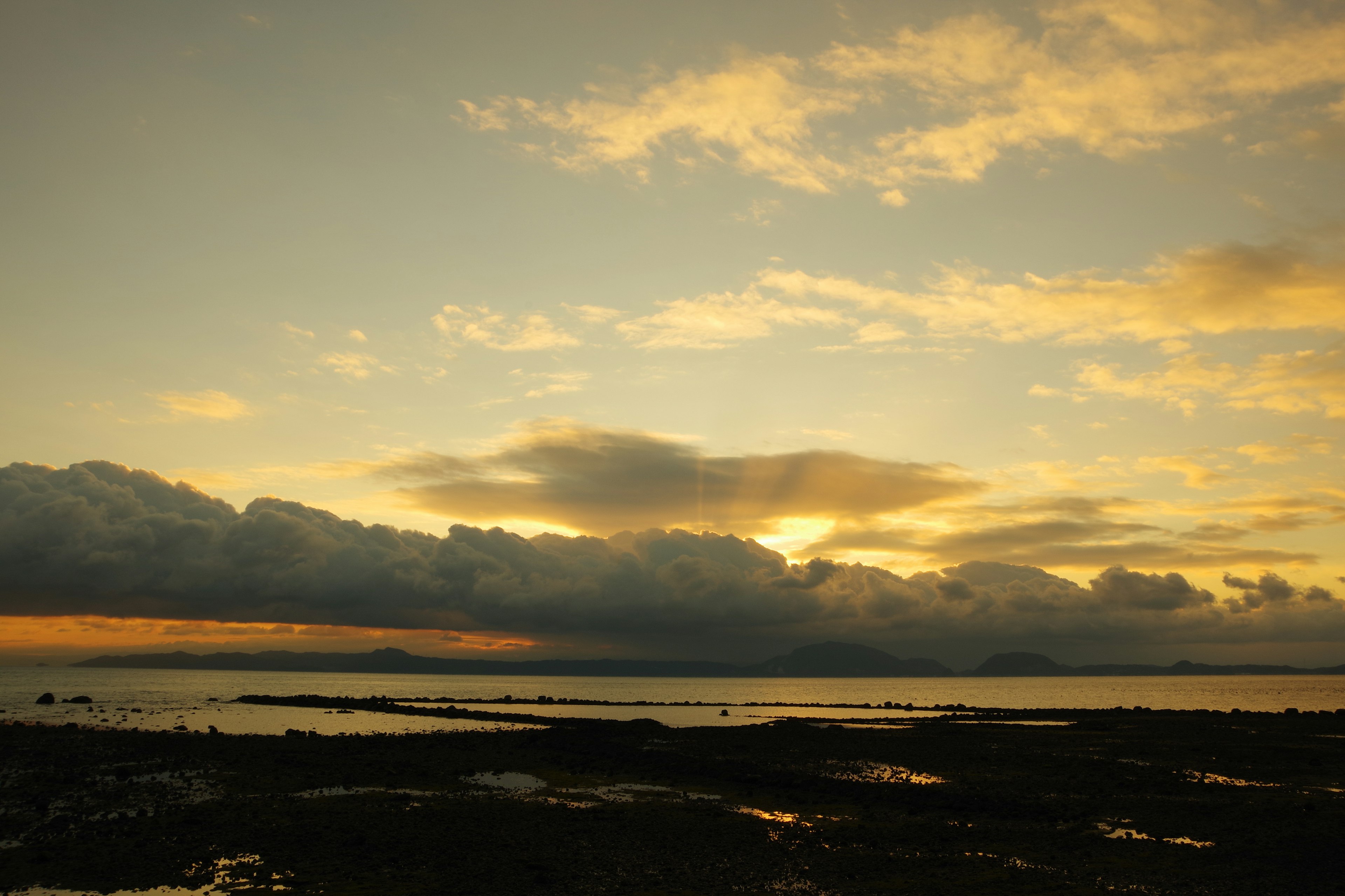 Sunset over the sea with clouds and orange light