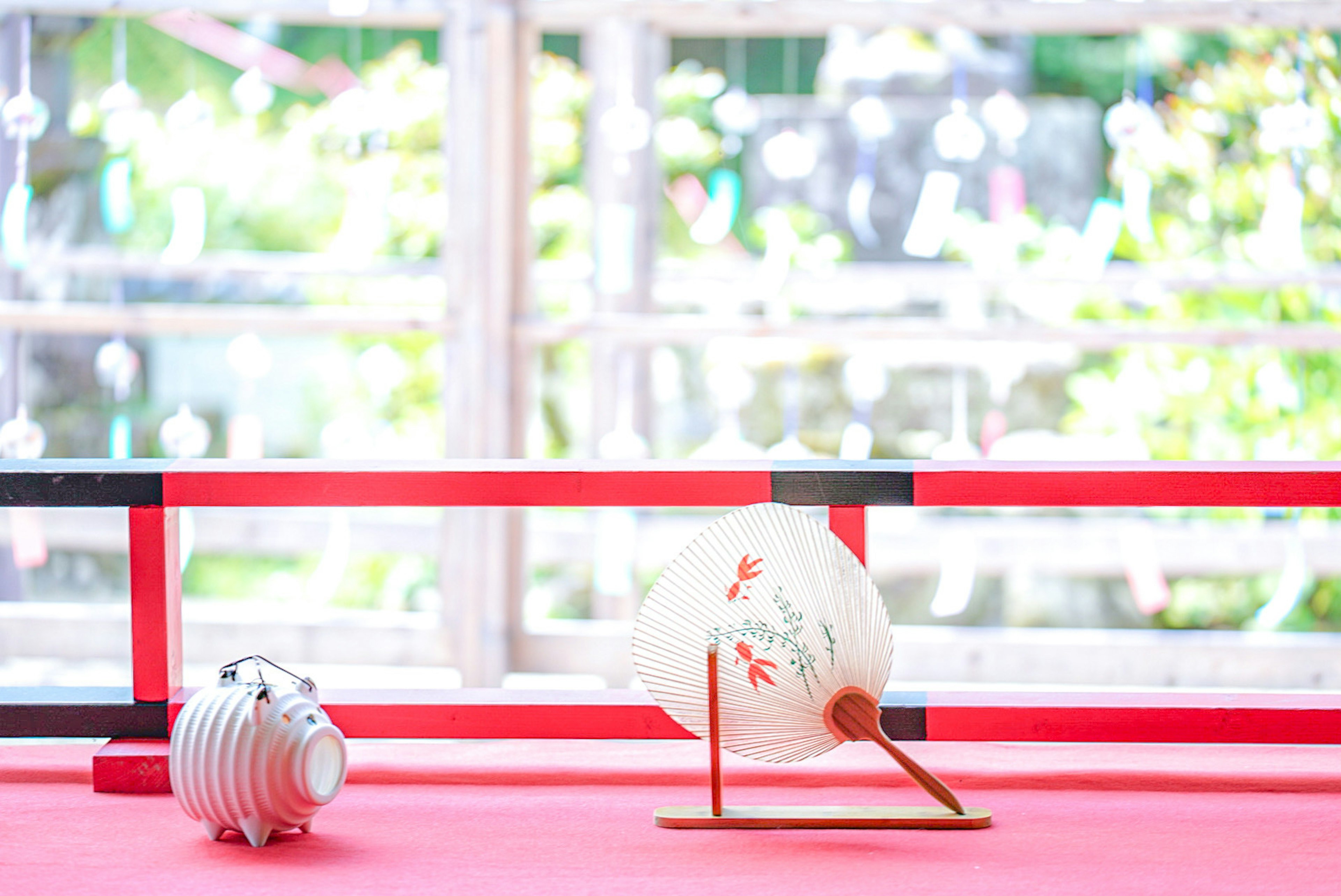 A white bird figurine and a striped pig figurine on a red background