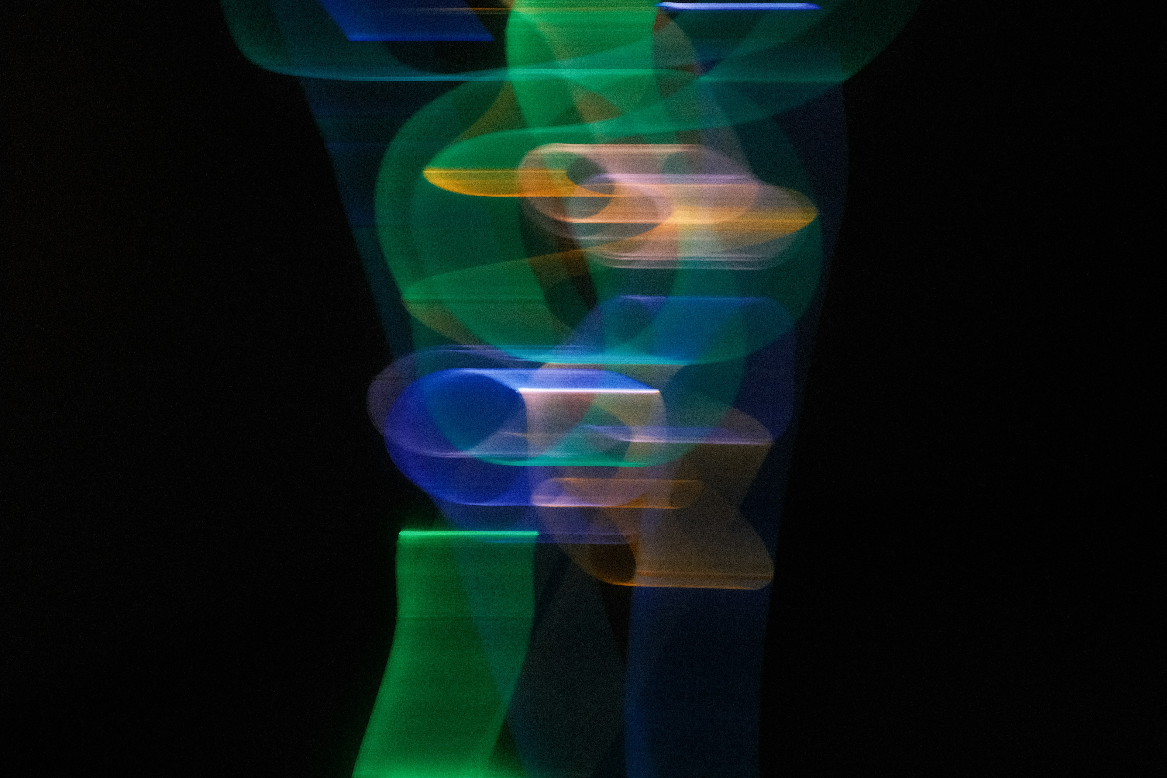 Abstract shapes with colorful light movements on a black background