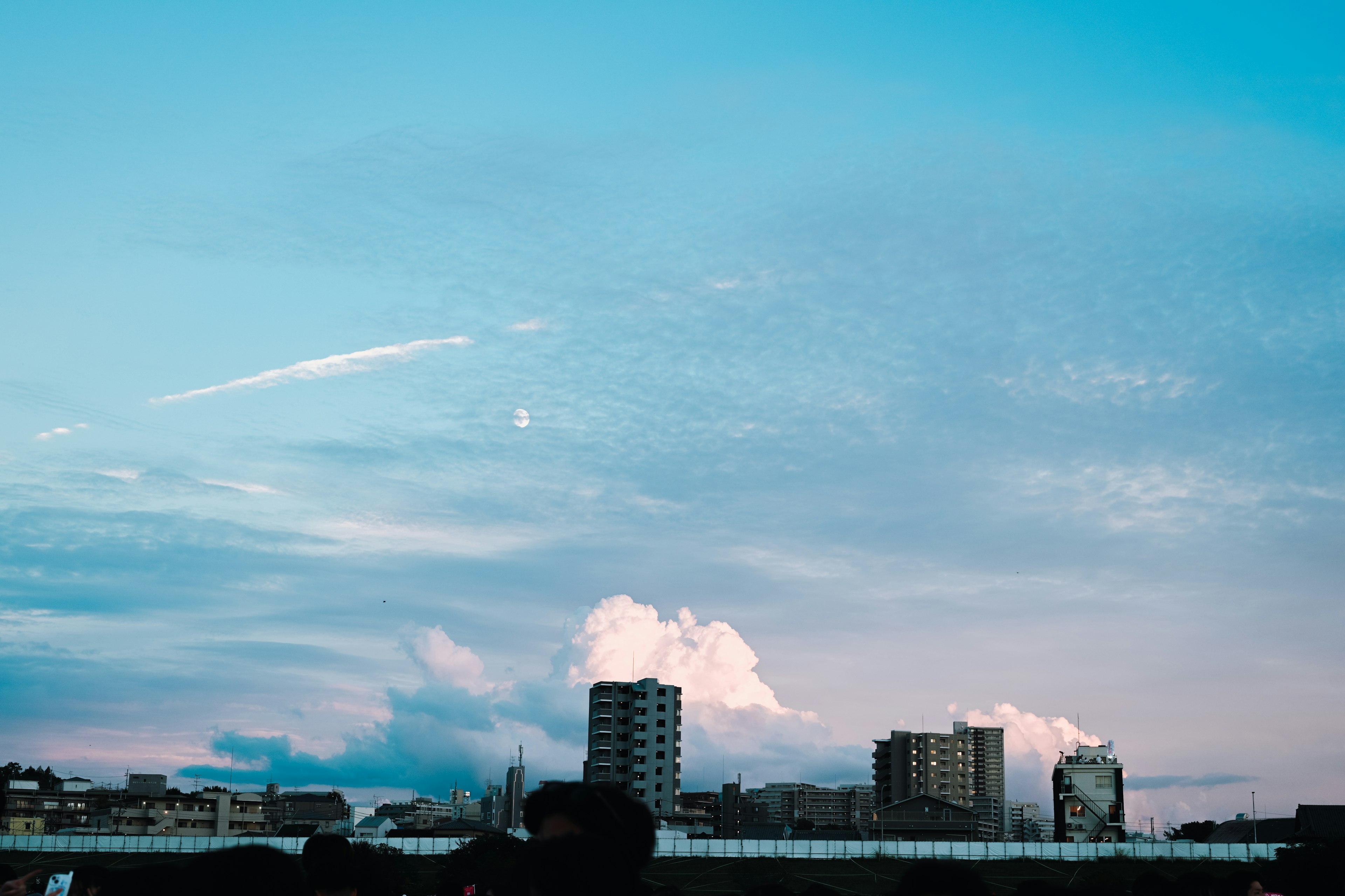 City skyline under a blue sky with clouds