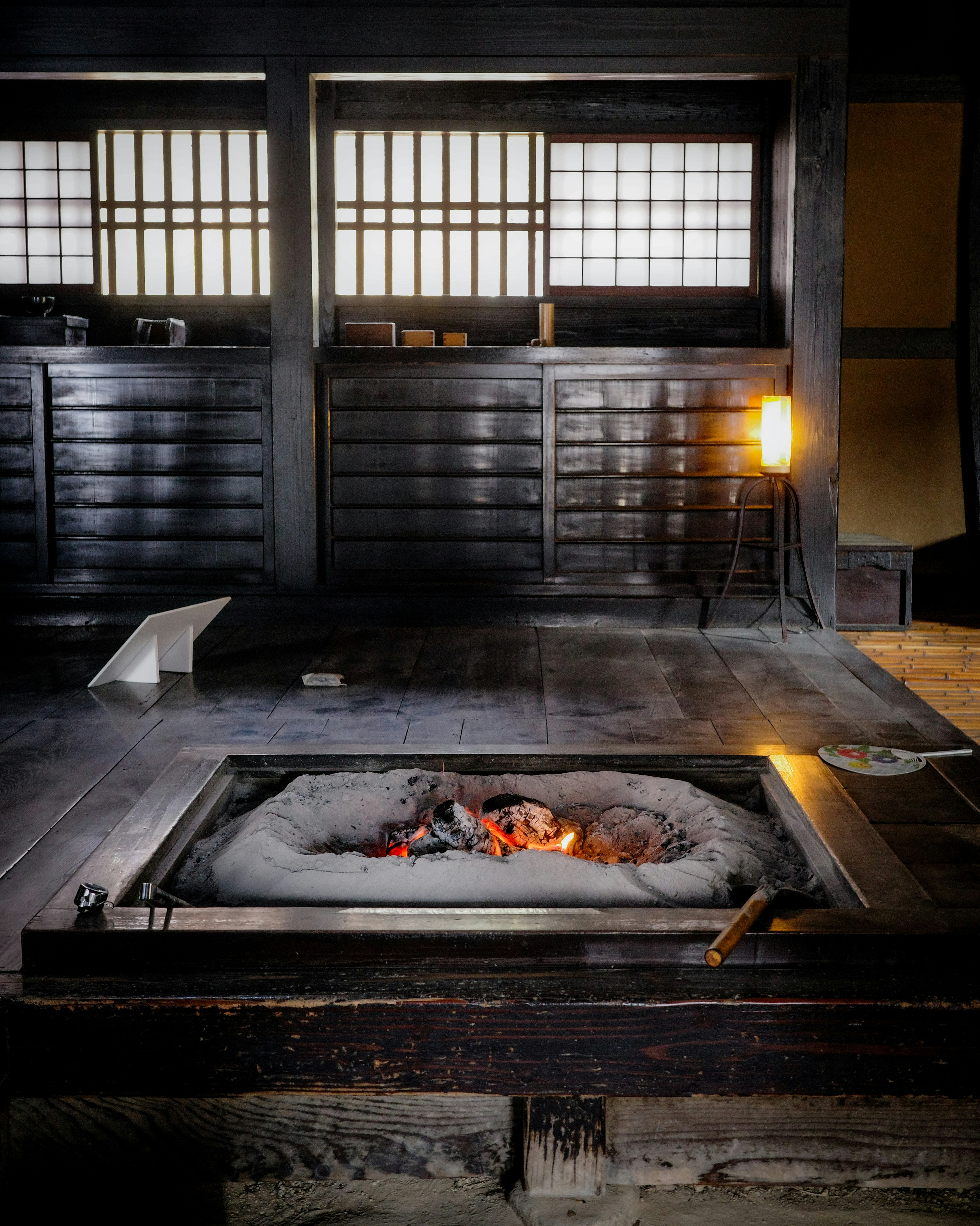 Traditional Japanese room interior with irori hearth wooden walls and shoji screens