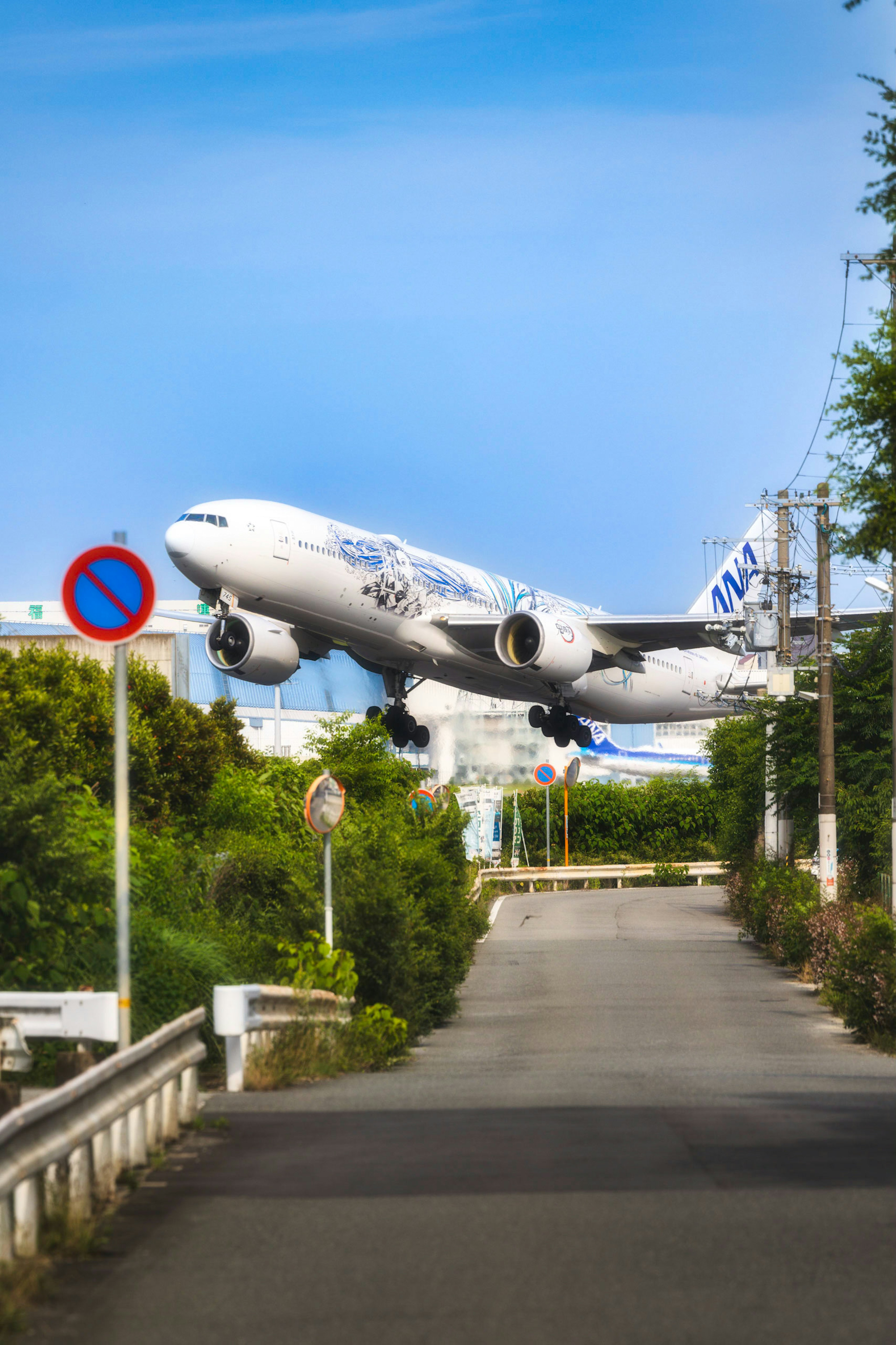 Image of an airplane landing with a clear blue sky background