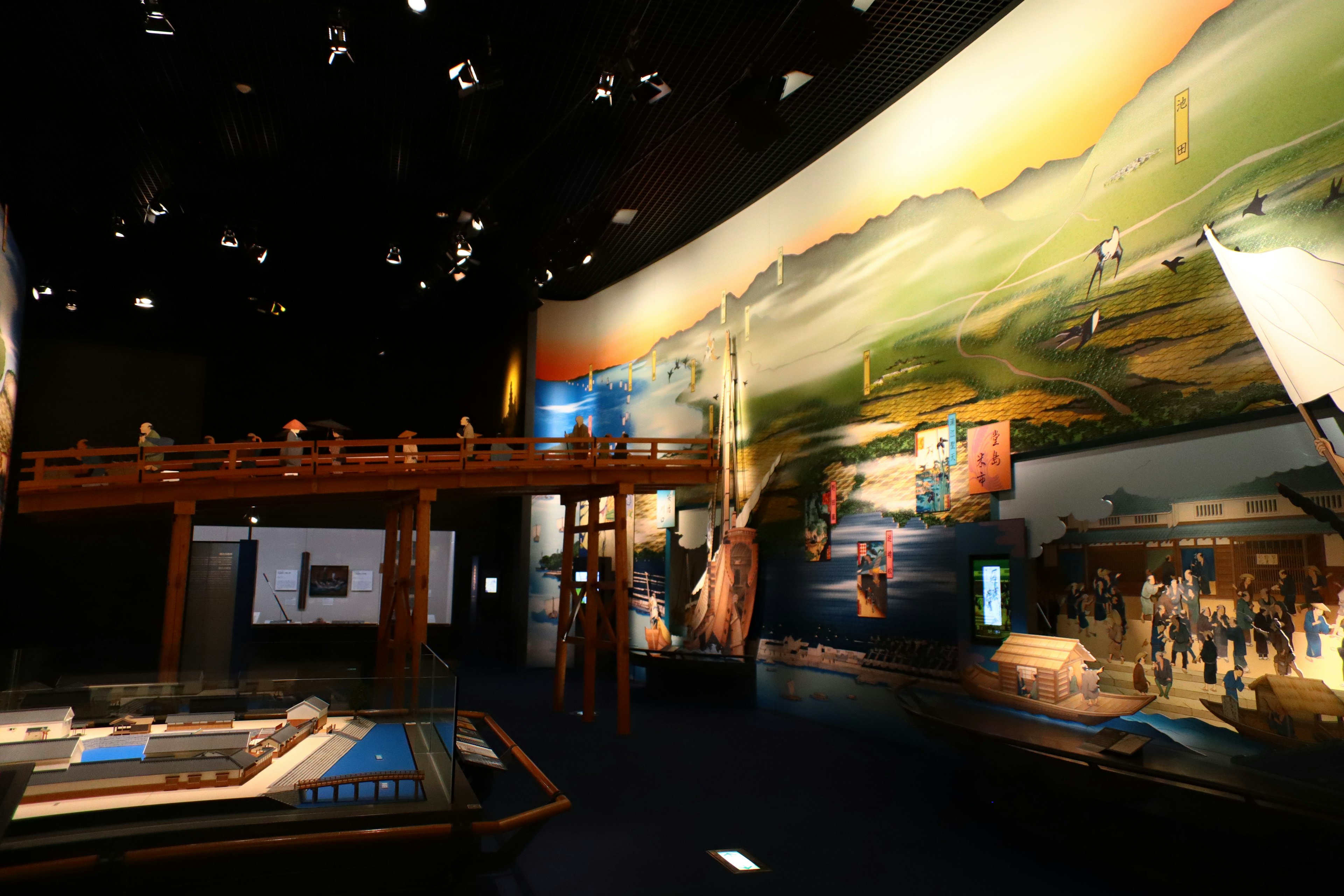 Interior of an exhibition space featuring large landscape murals