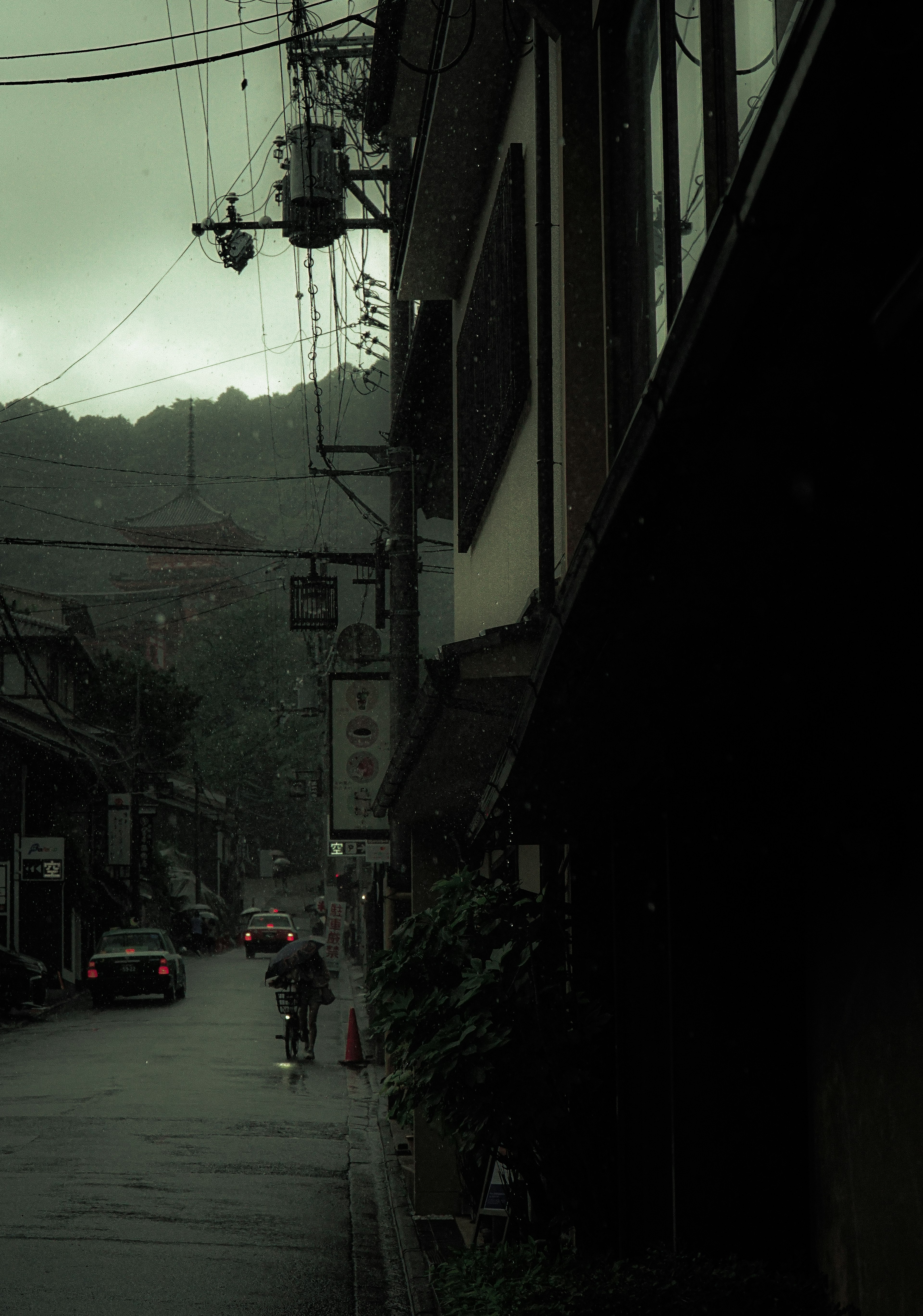 薄暗い街路と雨に濡れた建物の風景