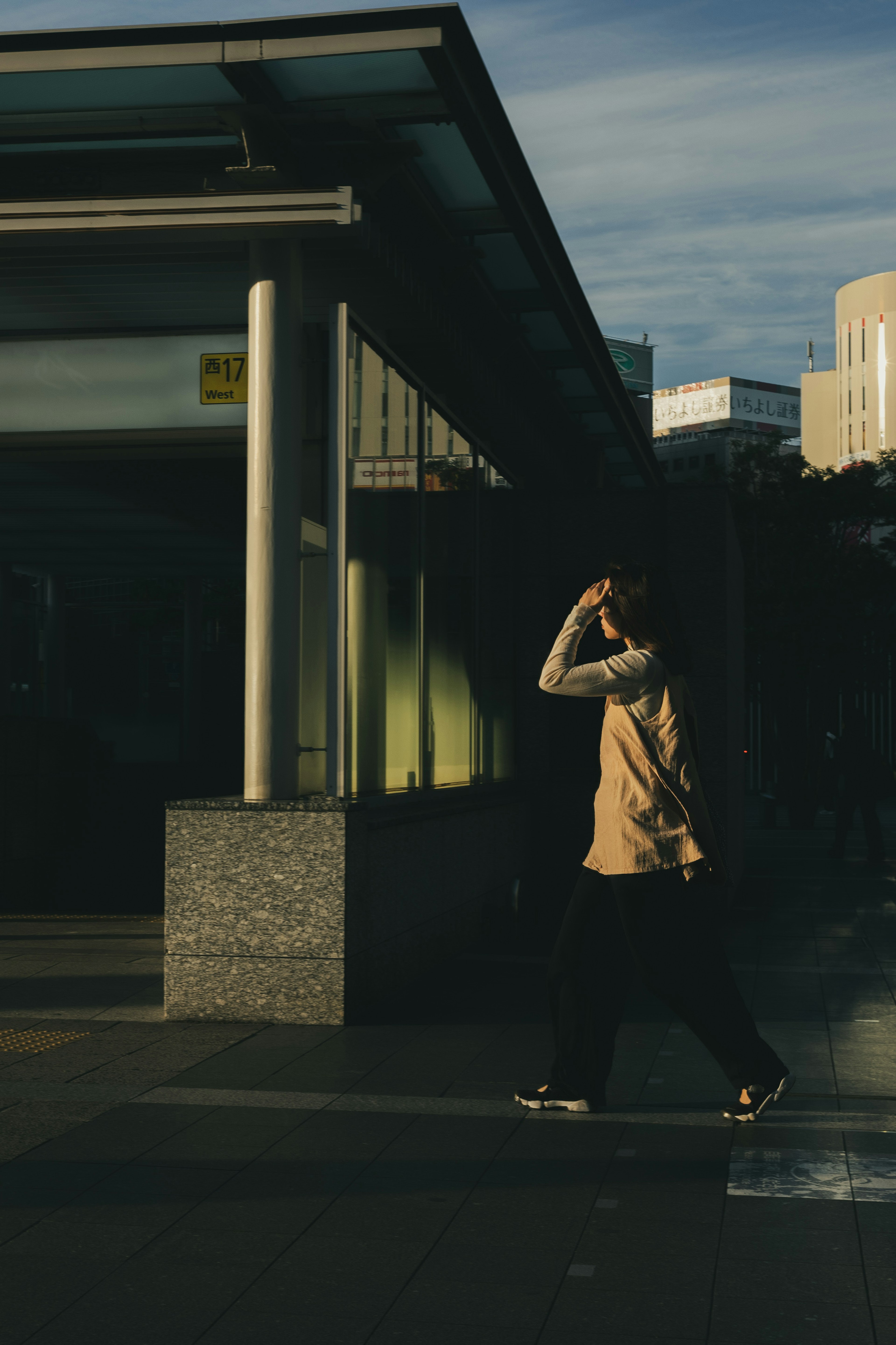 A person walking in an urban setting during the evening