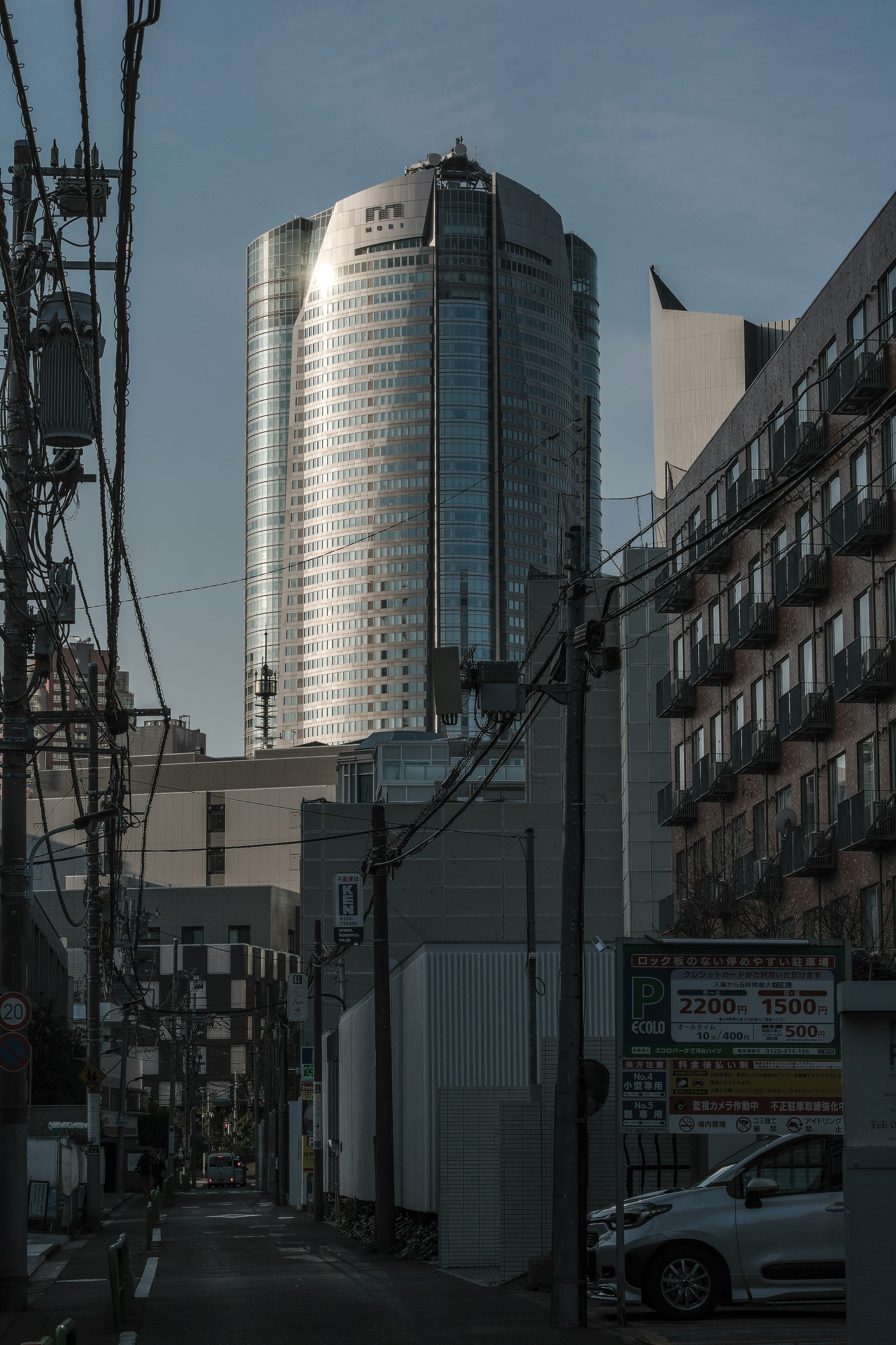 Urban landscape featuring a tall building and narrow street