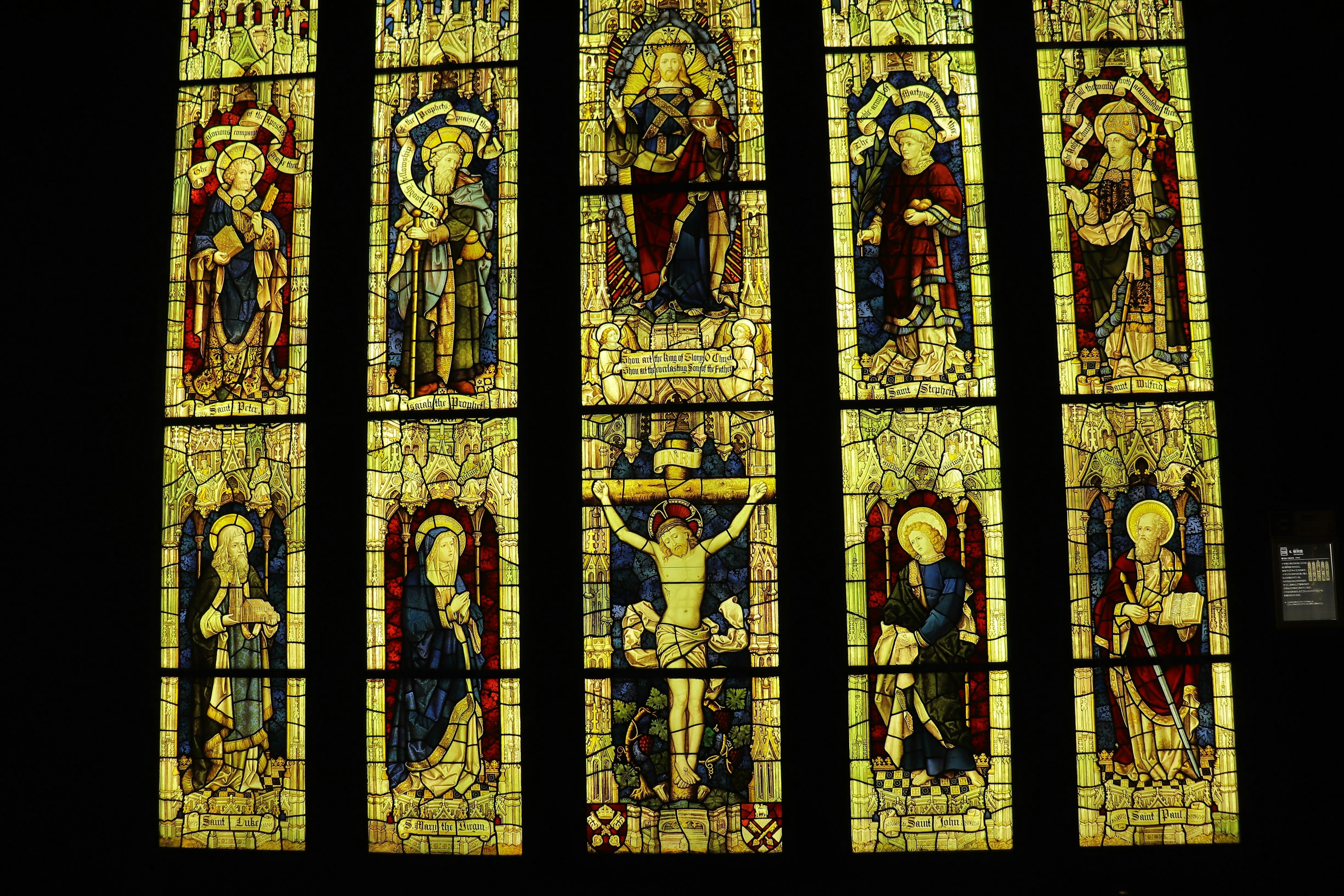 Beautiful stained glass window featuring saints and Jesus Christ on the cross