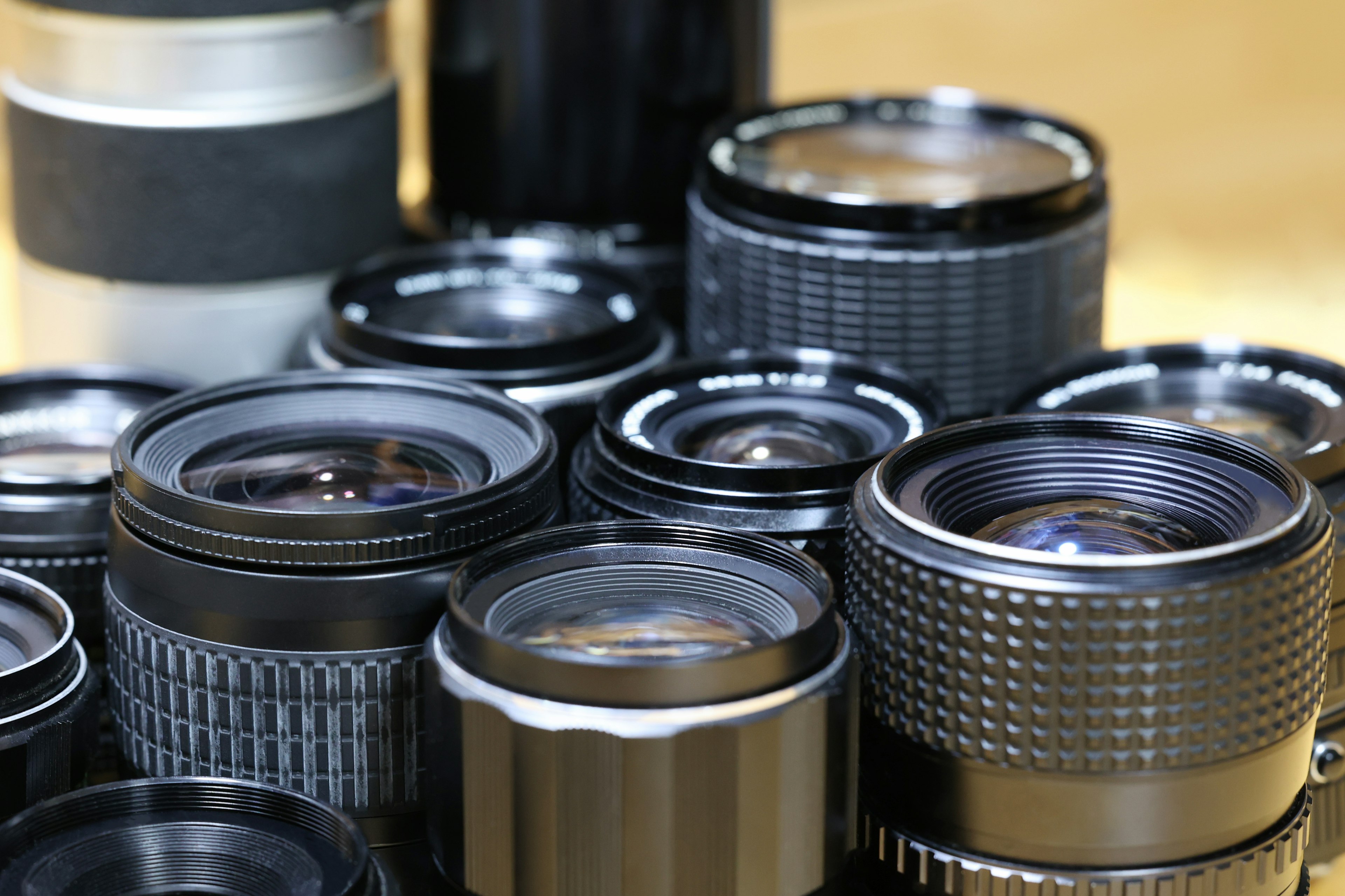 A collection of camera lenses arranged closely together