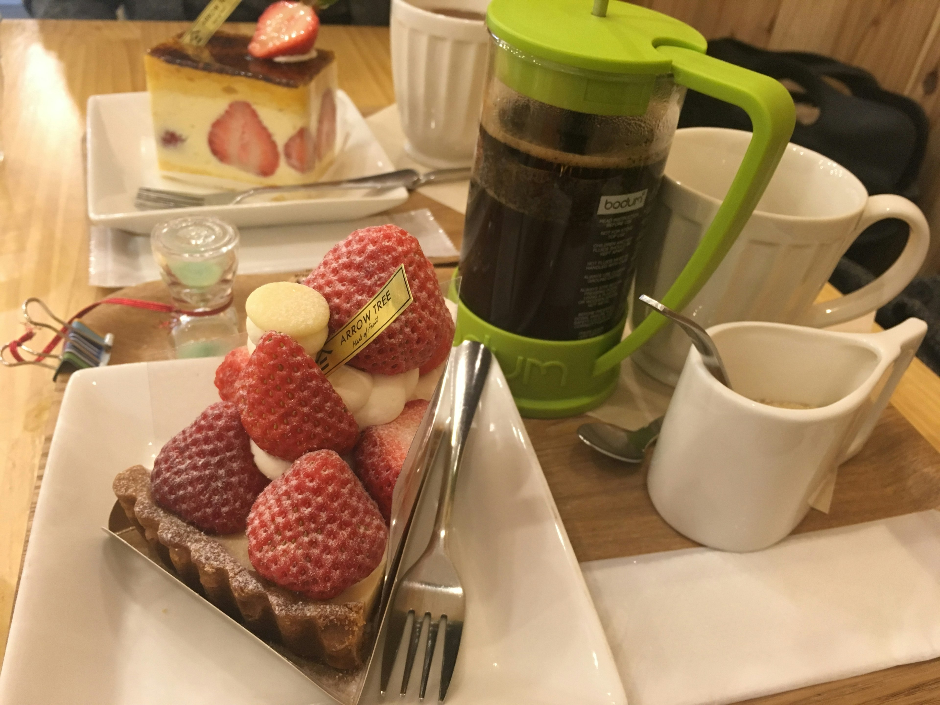 Ein Tisch mit einer Obsttorte und Kaffeeartikeln