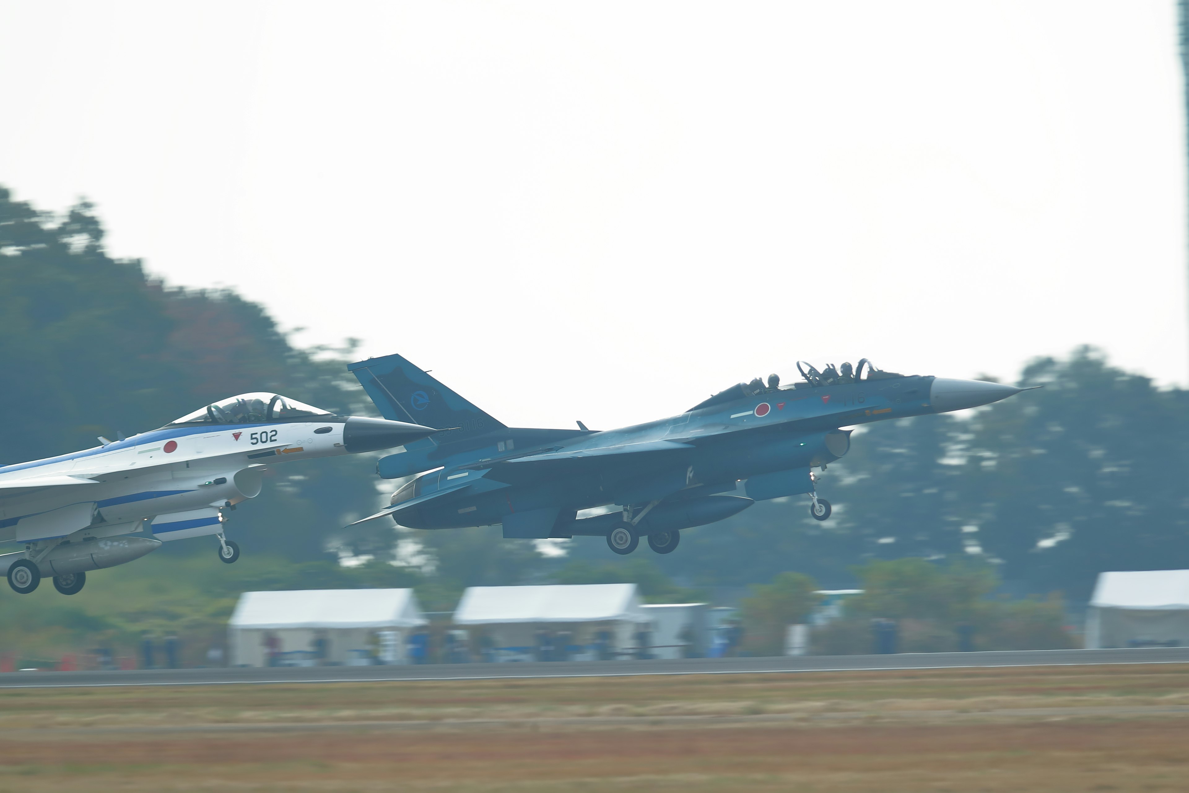 Two fighter jets taking off simultaneously