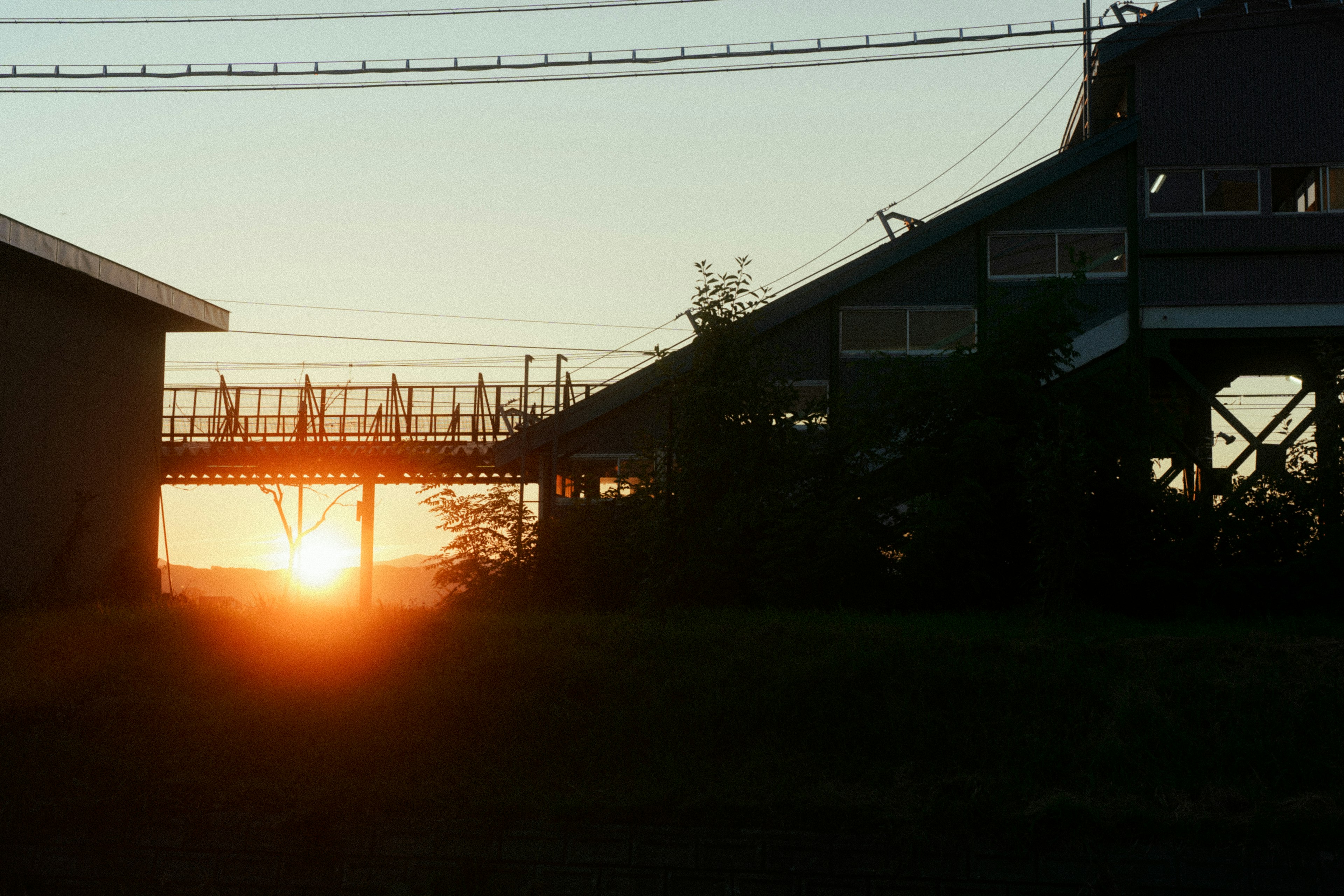 Silhouette of an industrial landscape with a setting sun