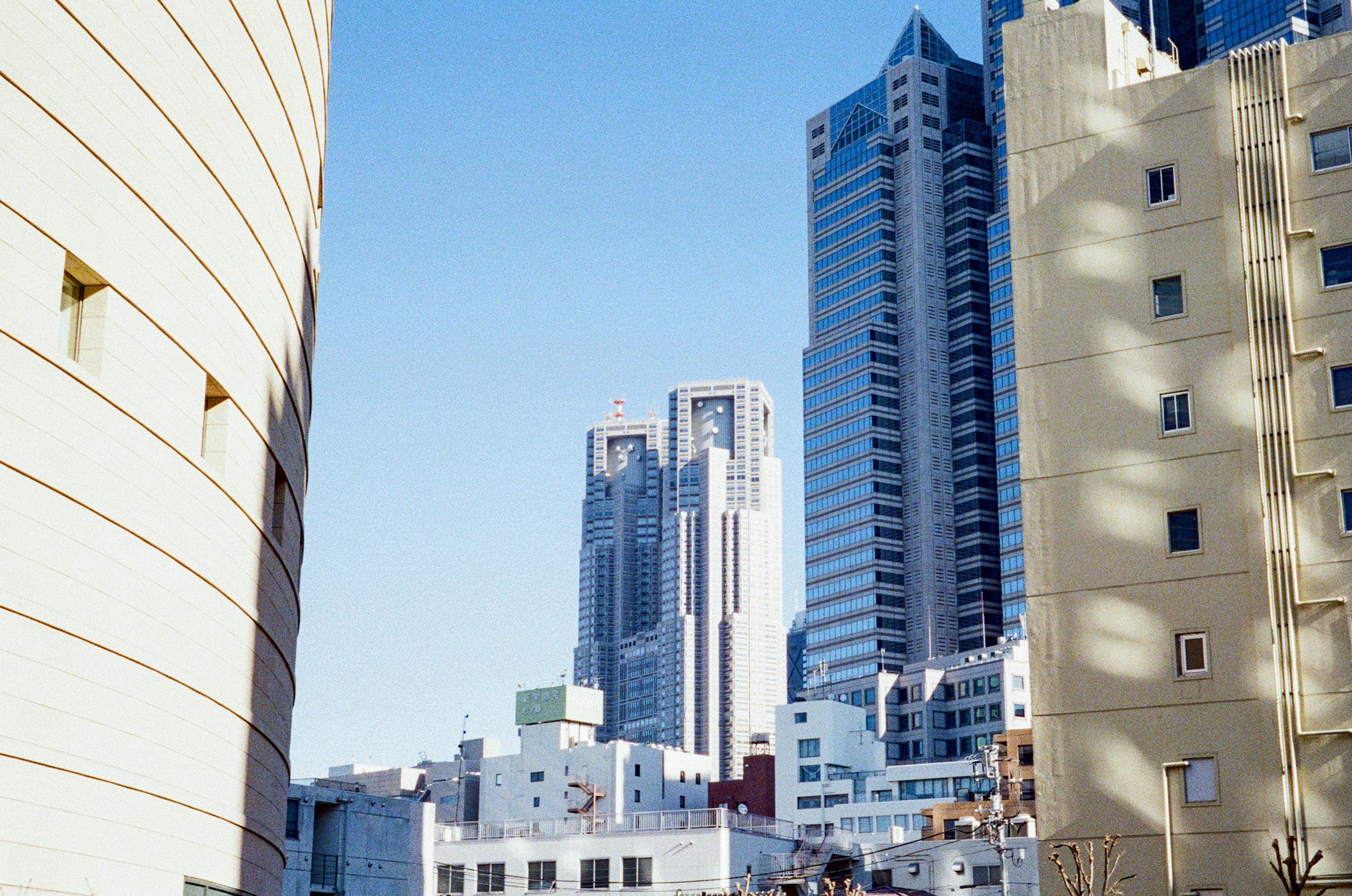 Cityscape featuring tall skyscrapers under a clear blue sky