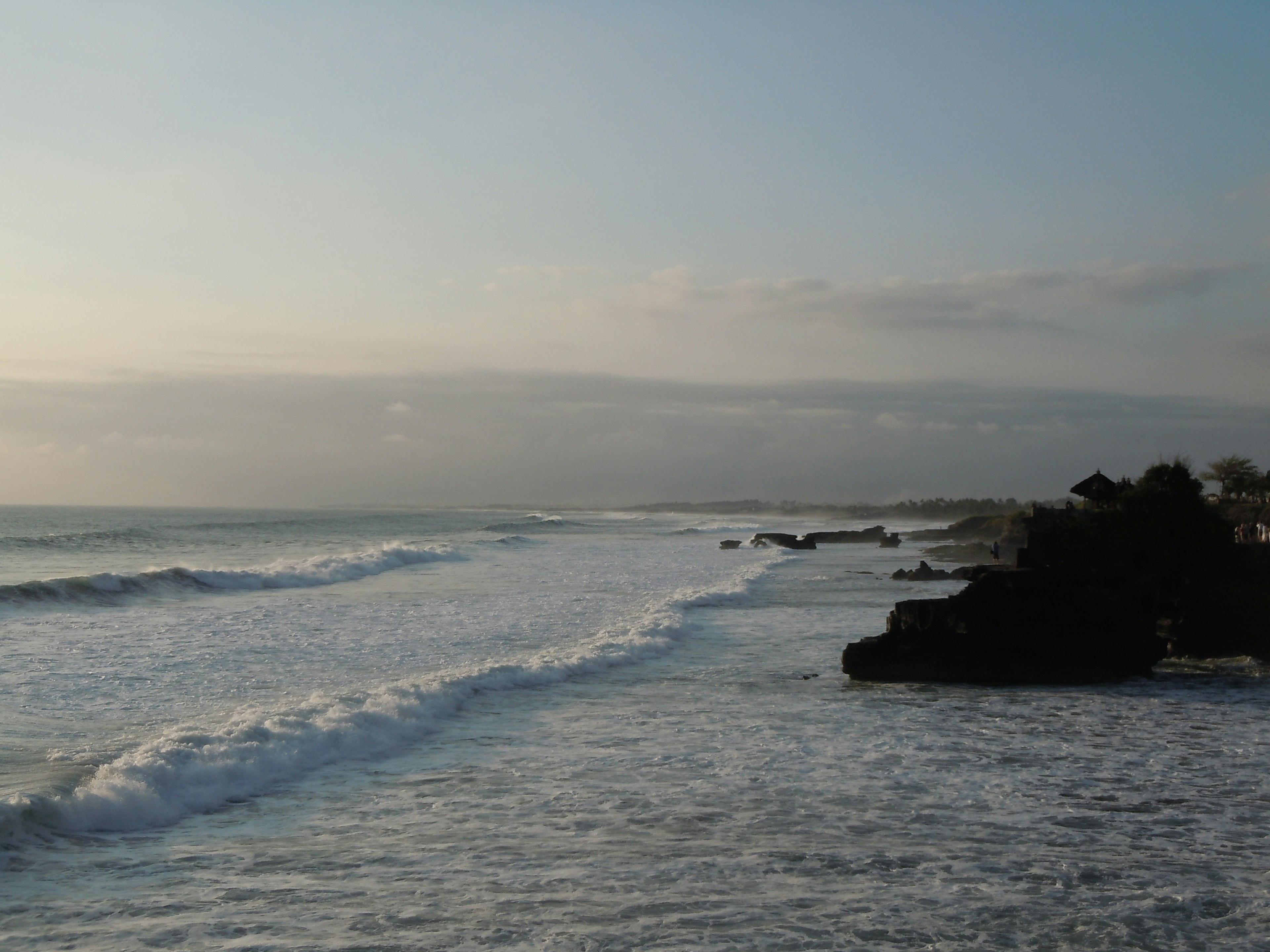 Serene coastline with gentle waves lapping at the shore