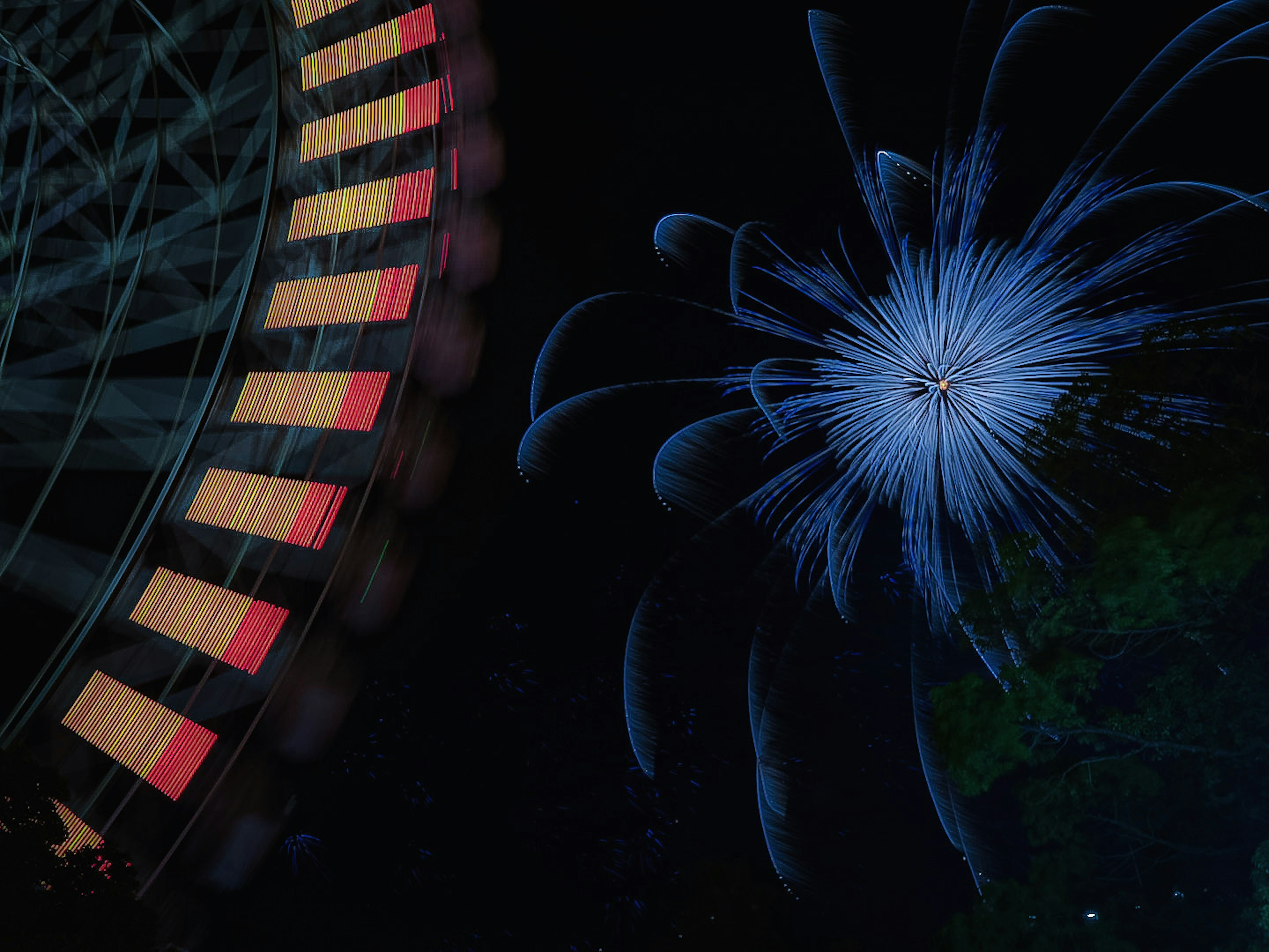 A beautiful scene featuring a ferris wheel and blue fireworks against the night sky