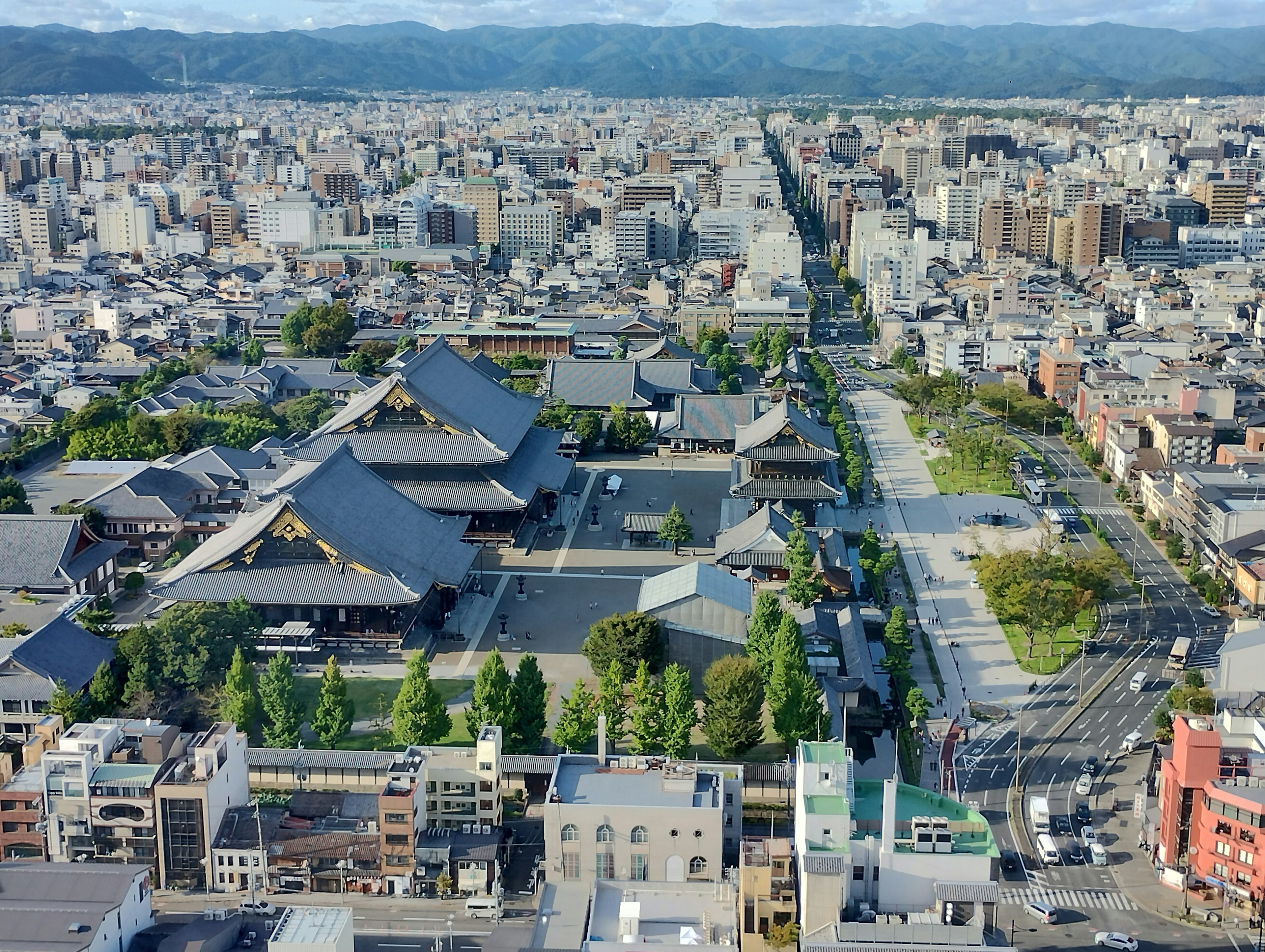 Vista aérea de un paisaje urbano con templos tradicionales y calles arboladas