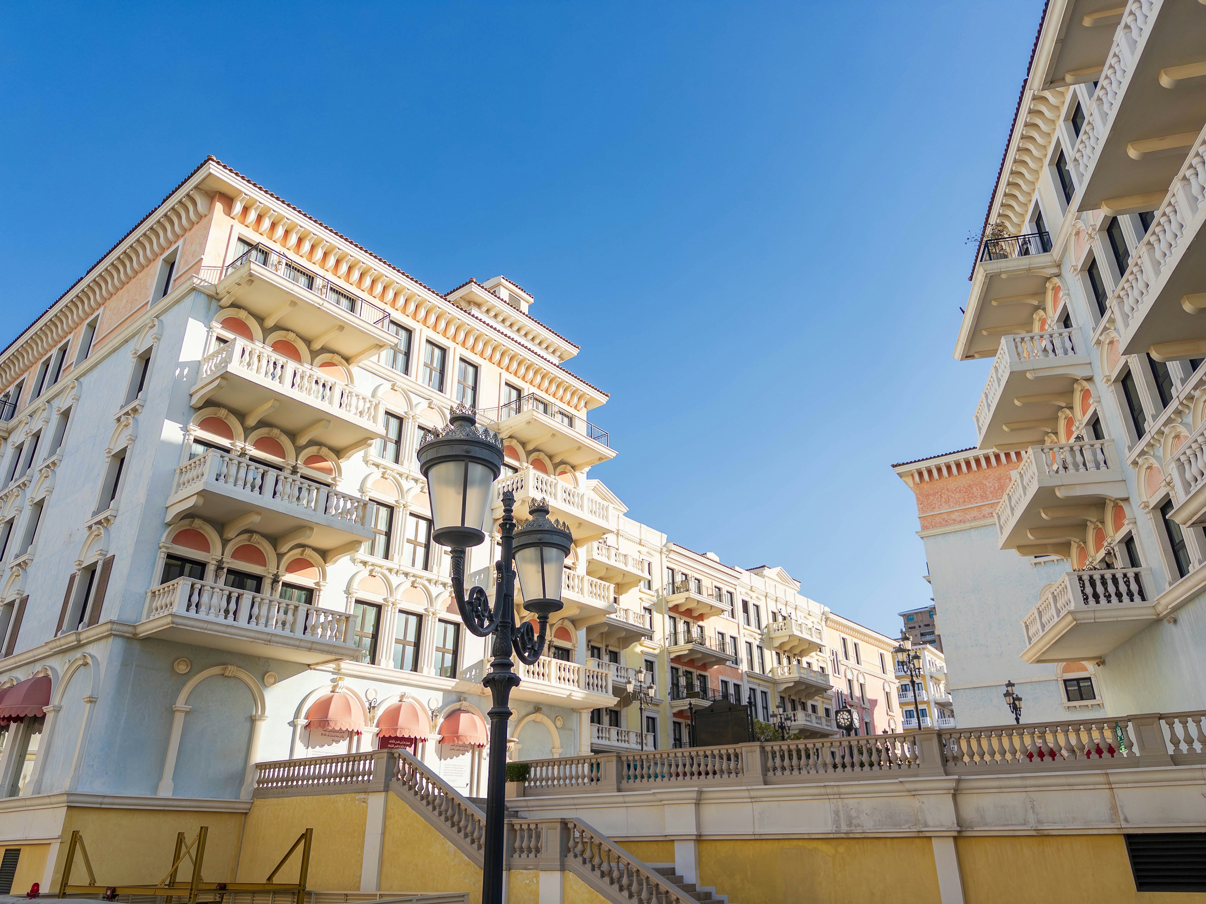 Beautiful row of buildings under a blue sky with a street lamp