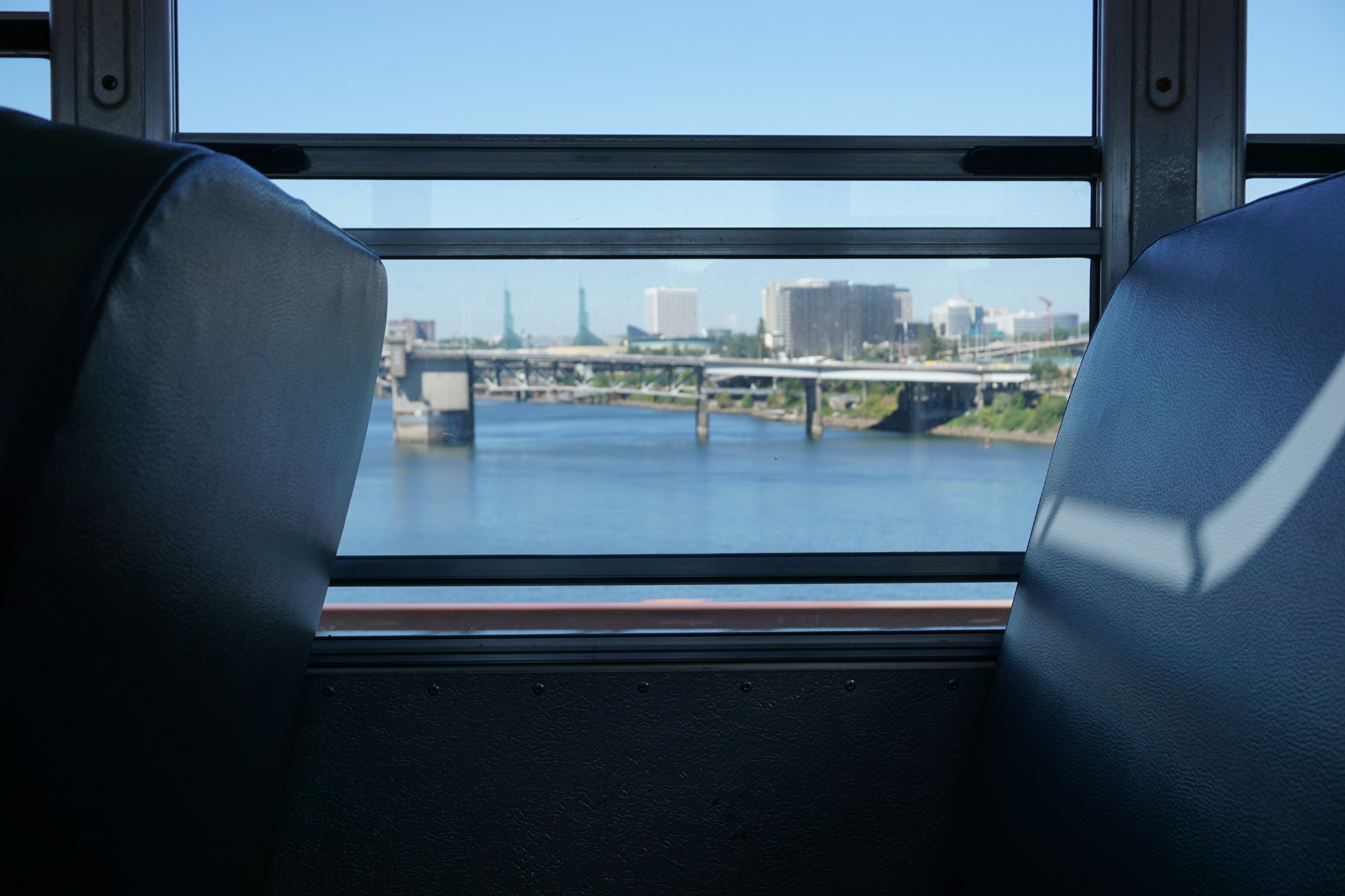 View of a river and bridge from a bus window