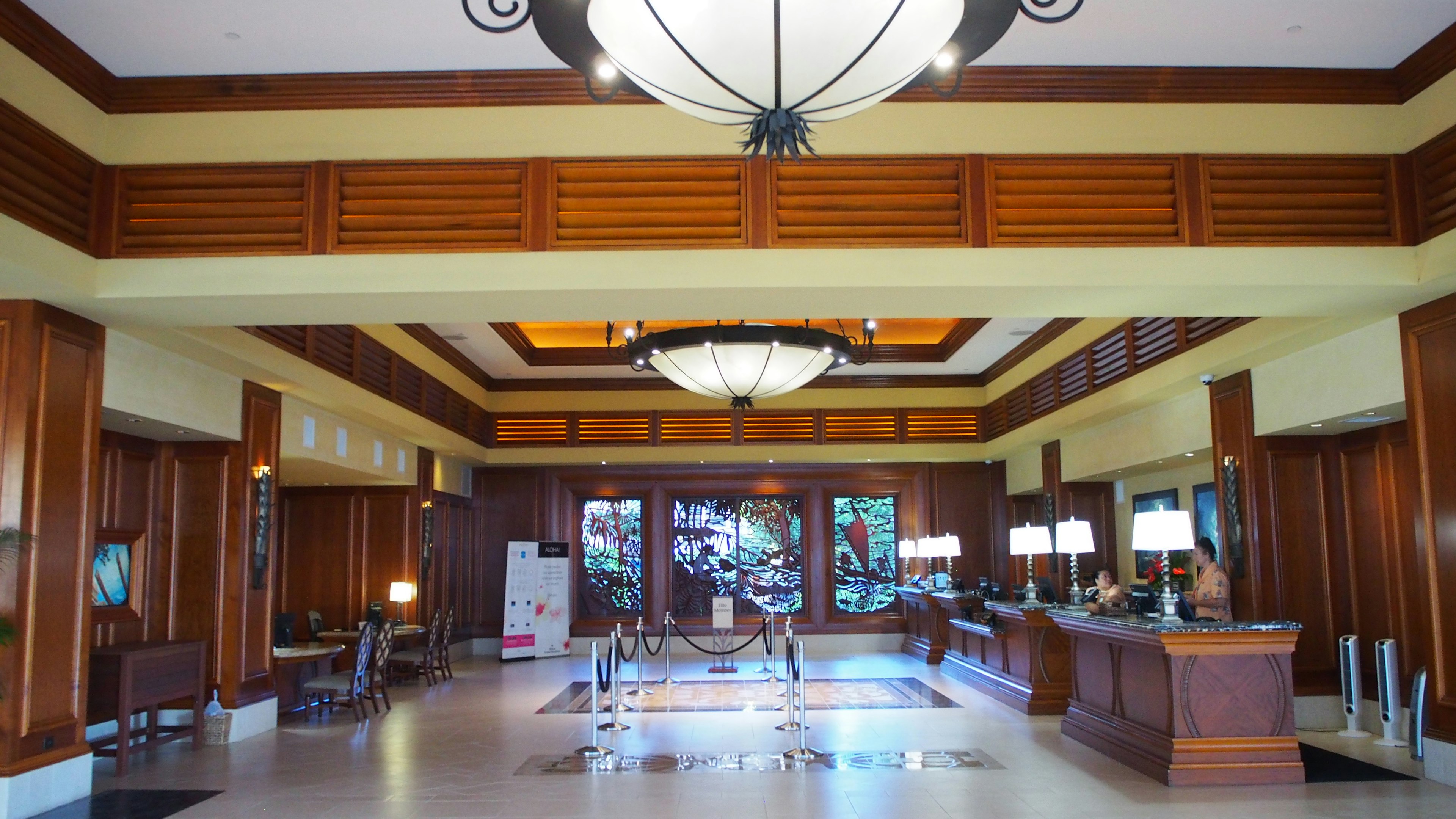 Spacious lobby interior featuring wooden decor and chandeliers