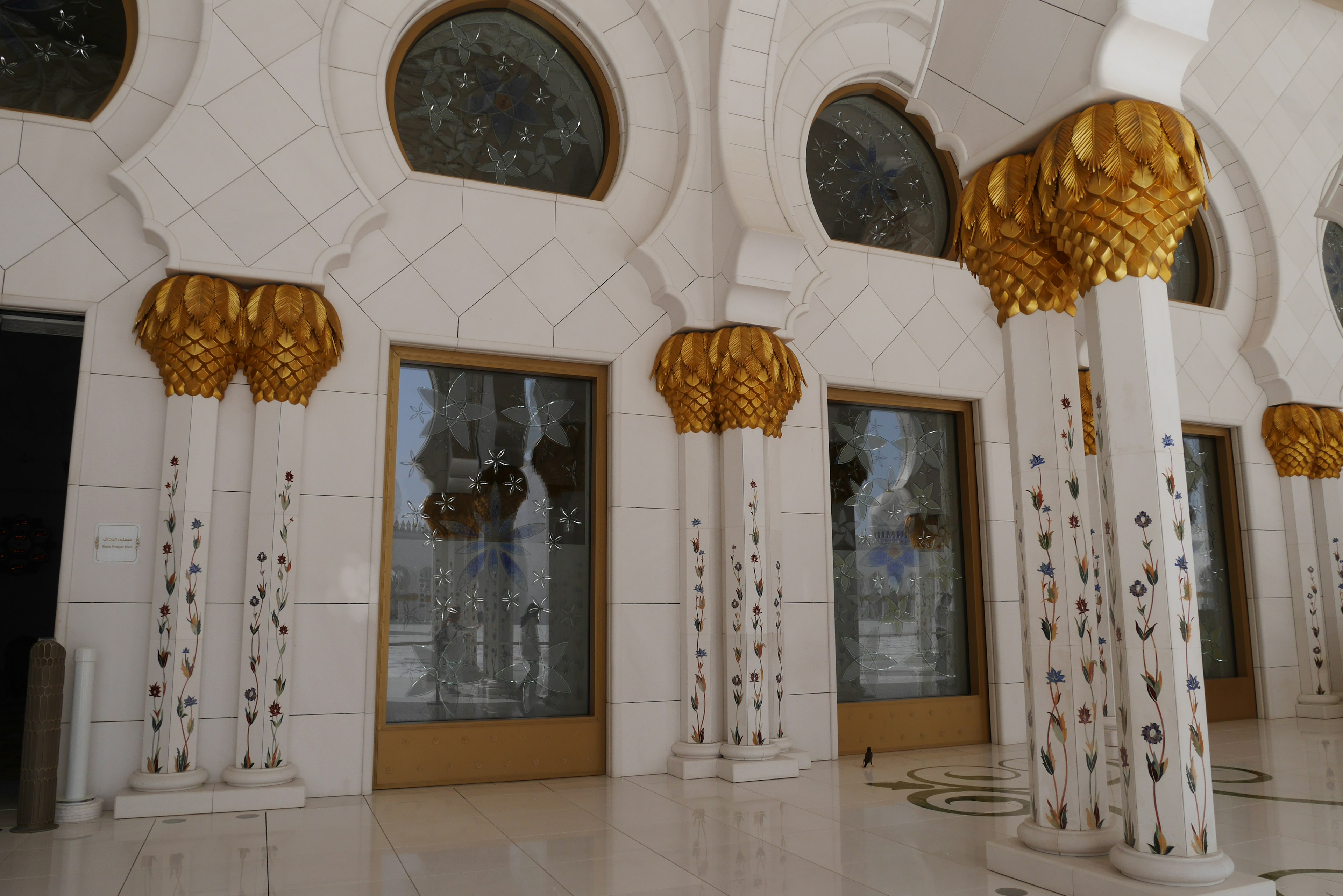 Interior of a beautiful building featuring marble columns and golden decorations