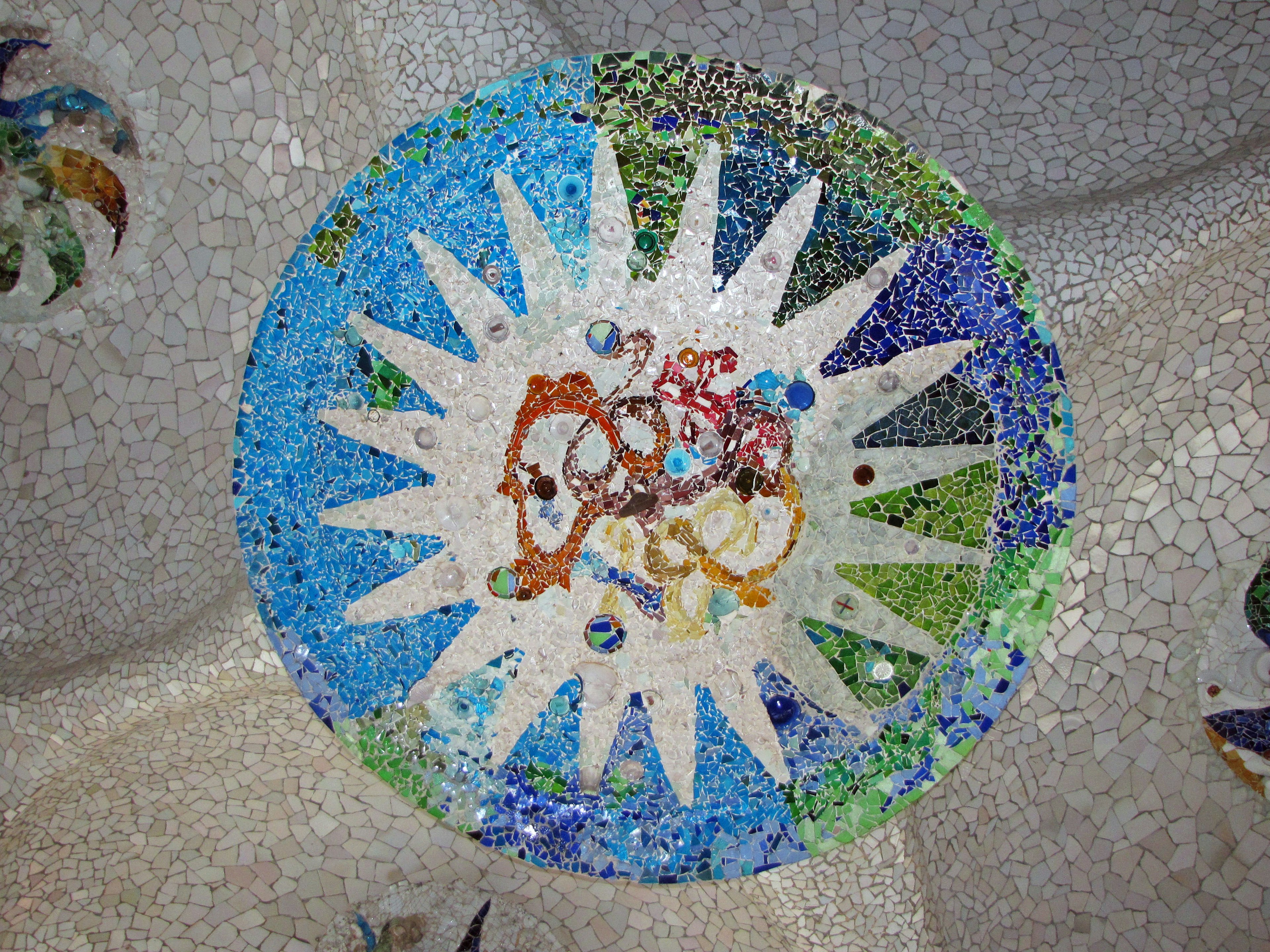 Colorful mosaic tile circular design featuring shades of blue and green