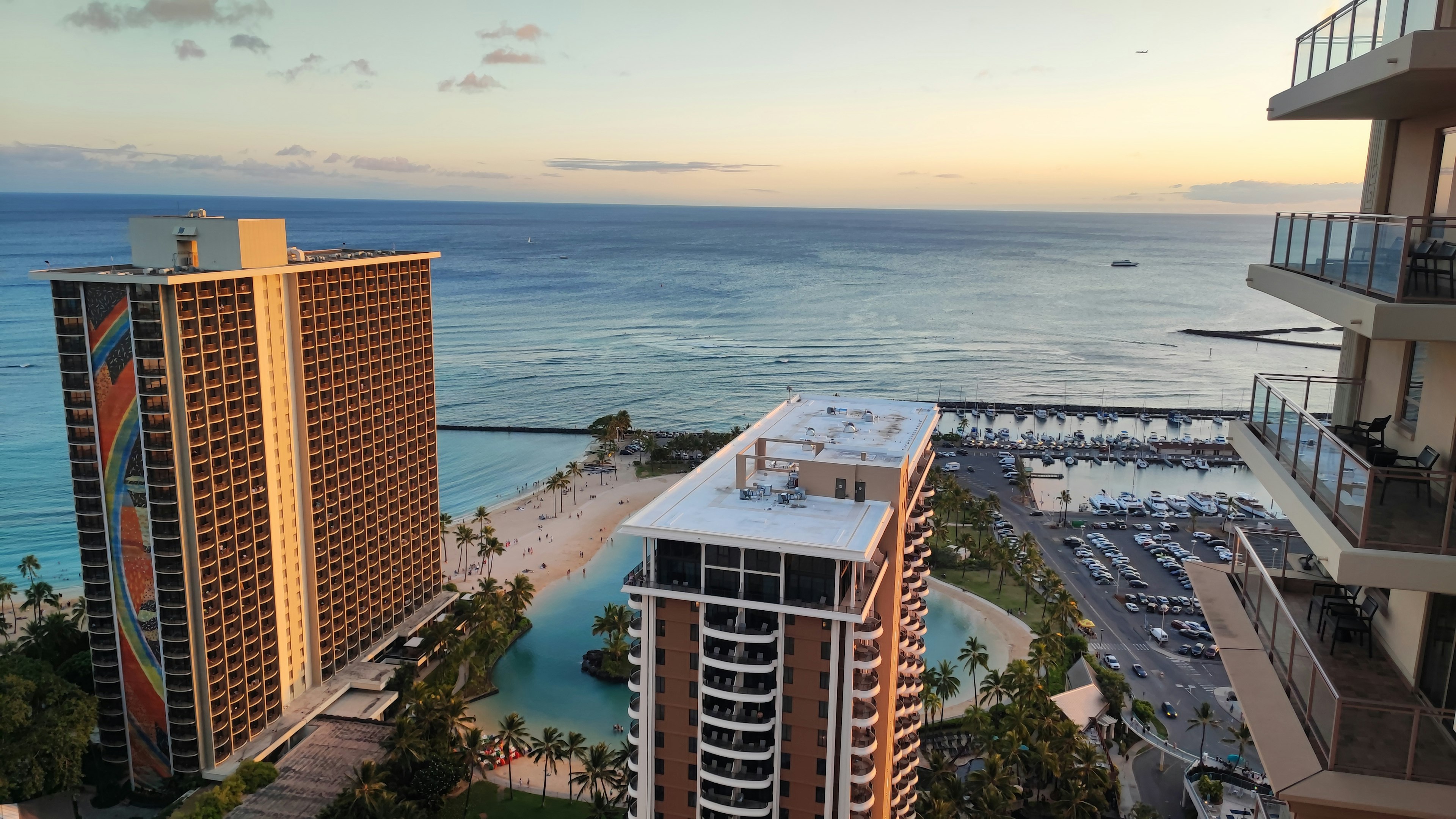 Aerial view of high-rise buildings by the ocean during sunset in Hawaii