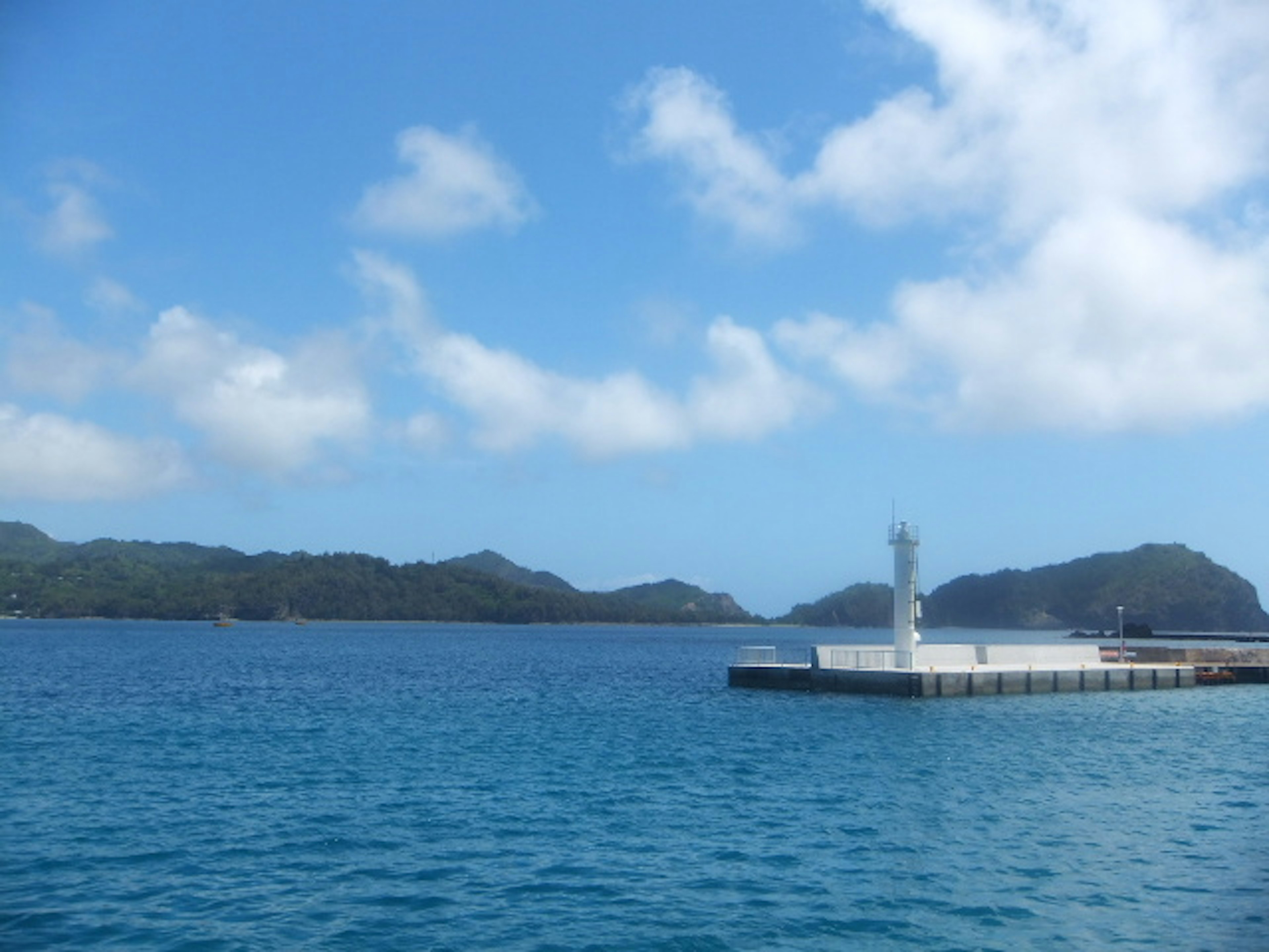 Beautiful harbor scene with blue water and white clouds