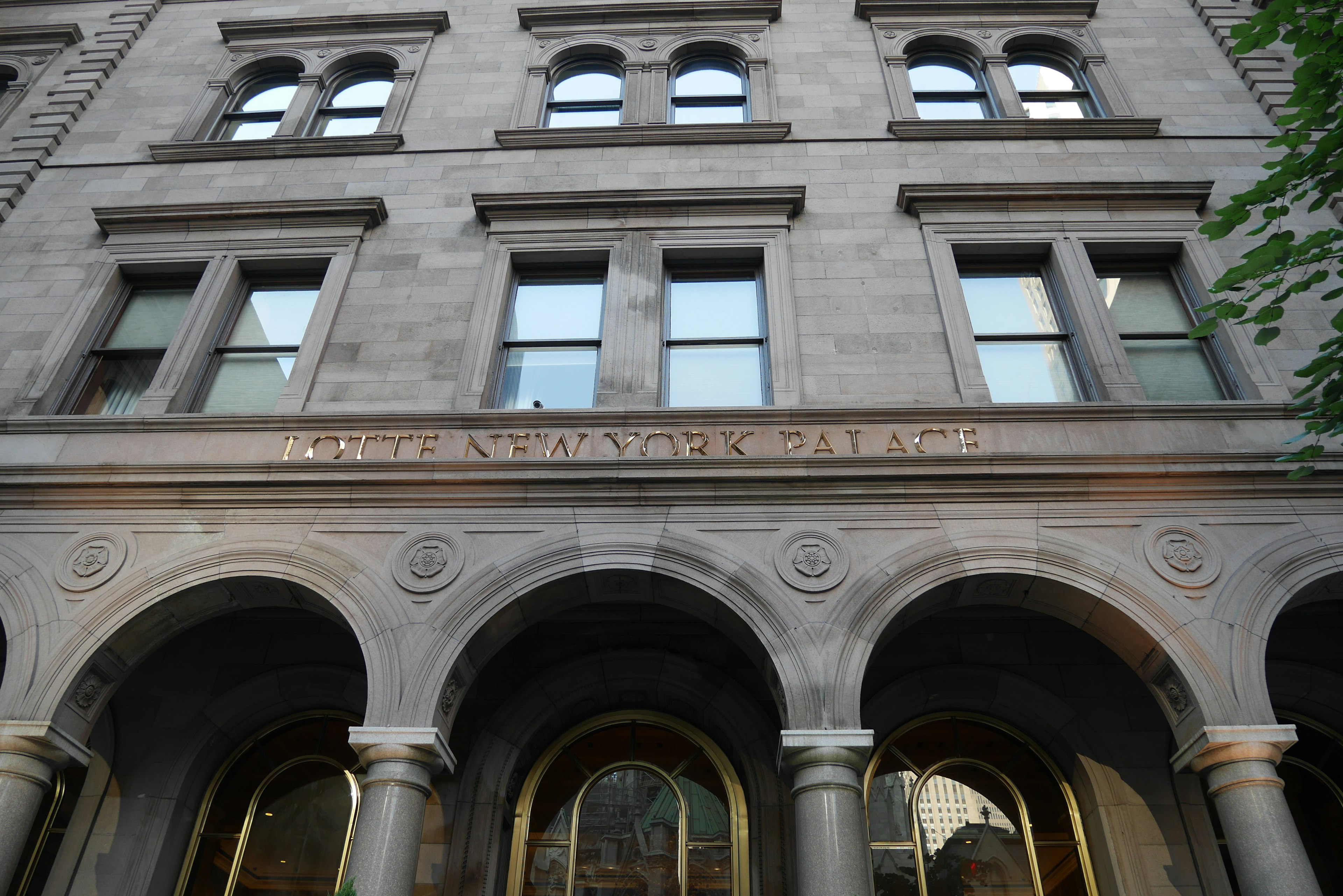 Facade of a classical building featuring arched windows and decorative columns