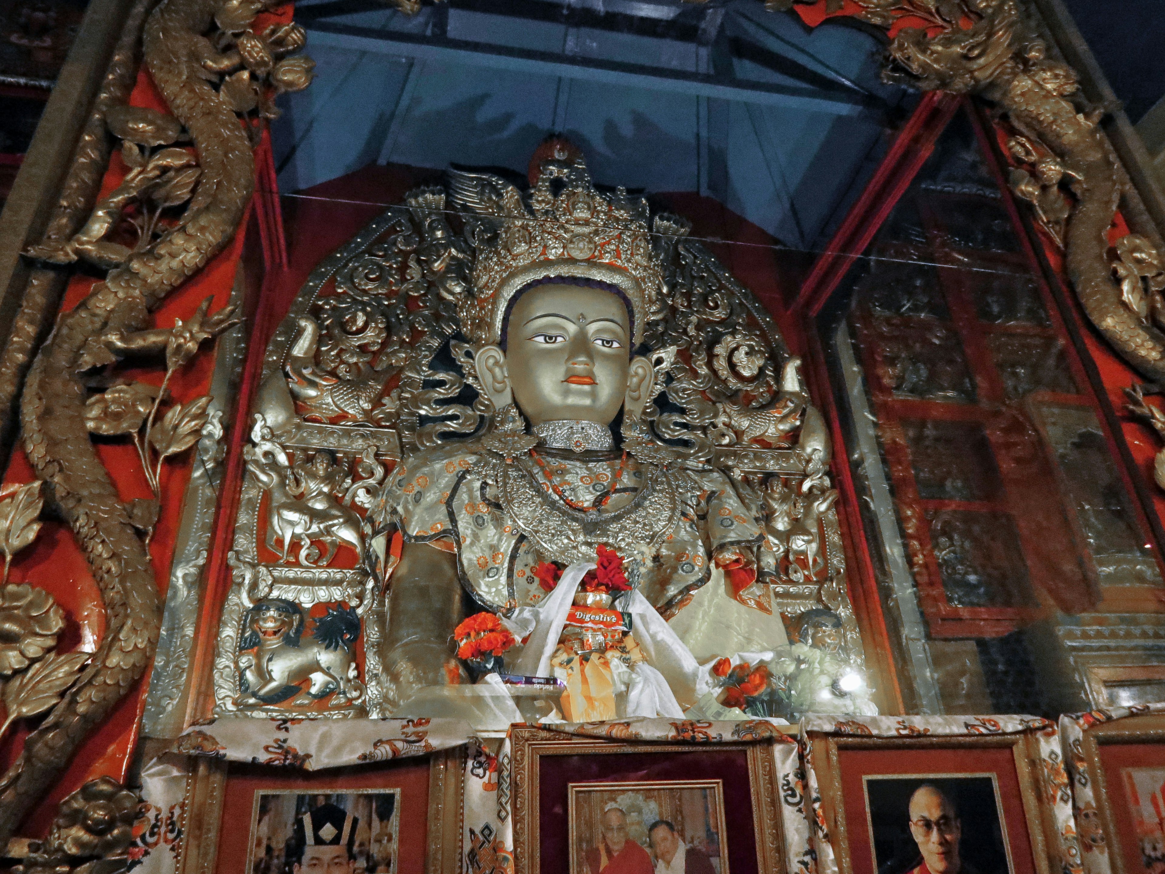 Große Buddha-Statue mit kunstvollem Hintergrund im Inneren eines Tempels