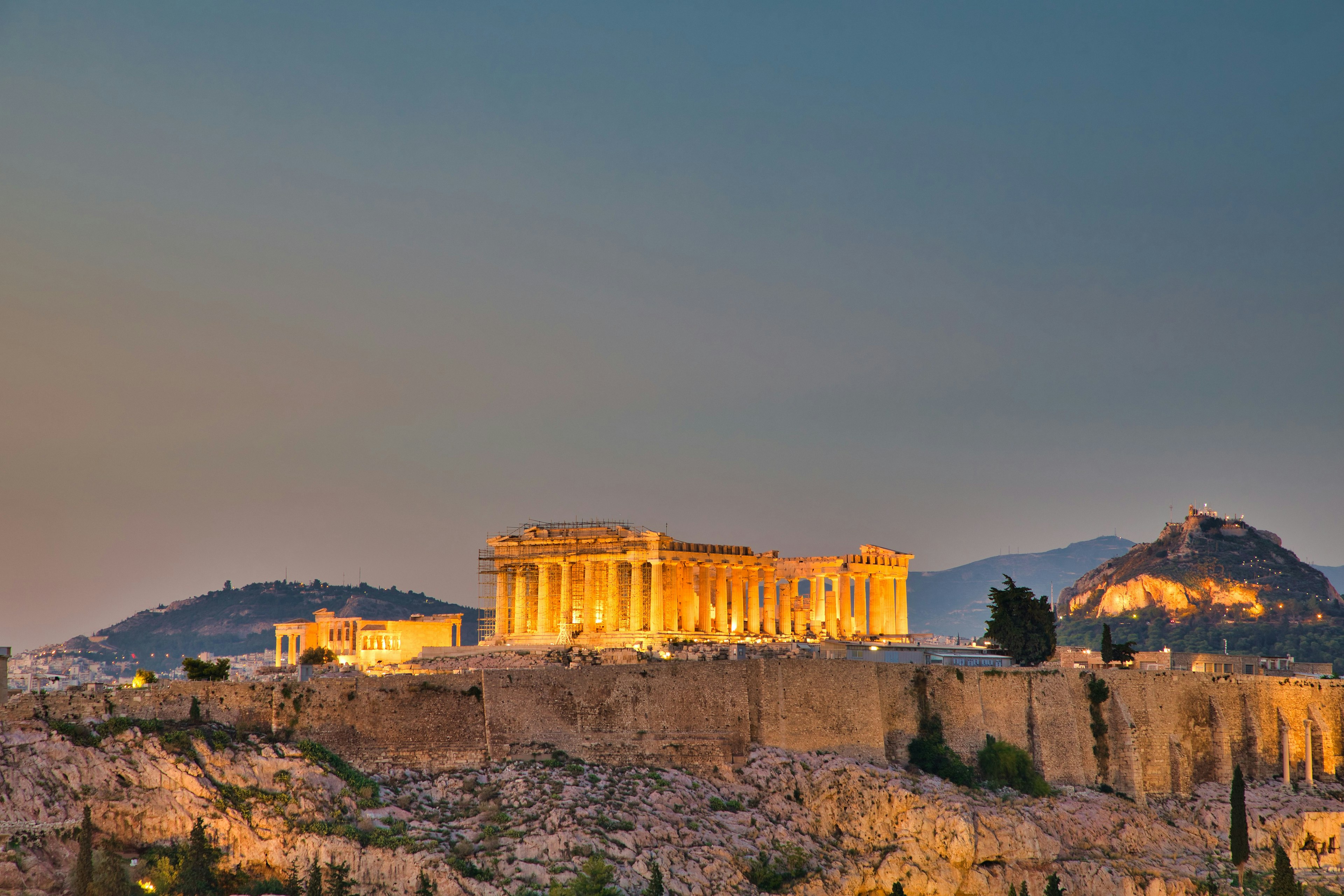 The majestic view of the Acropolis illuminated at dusk