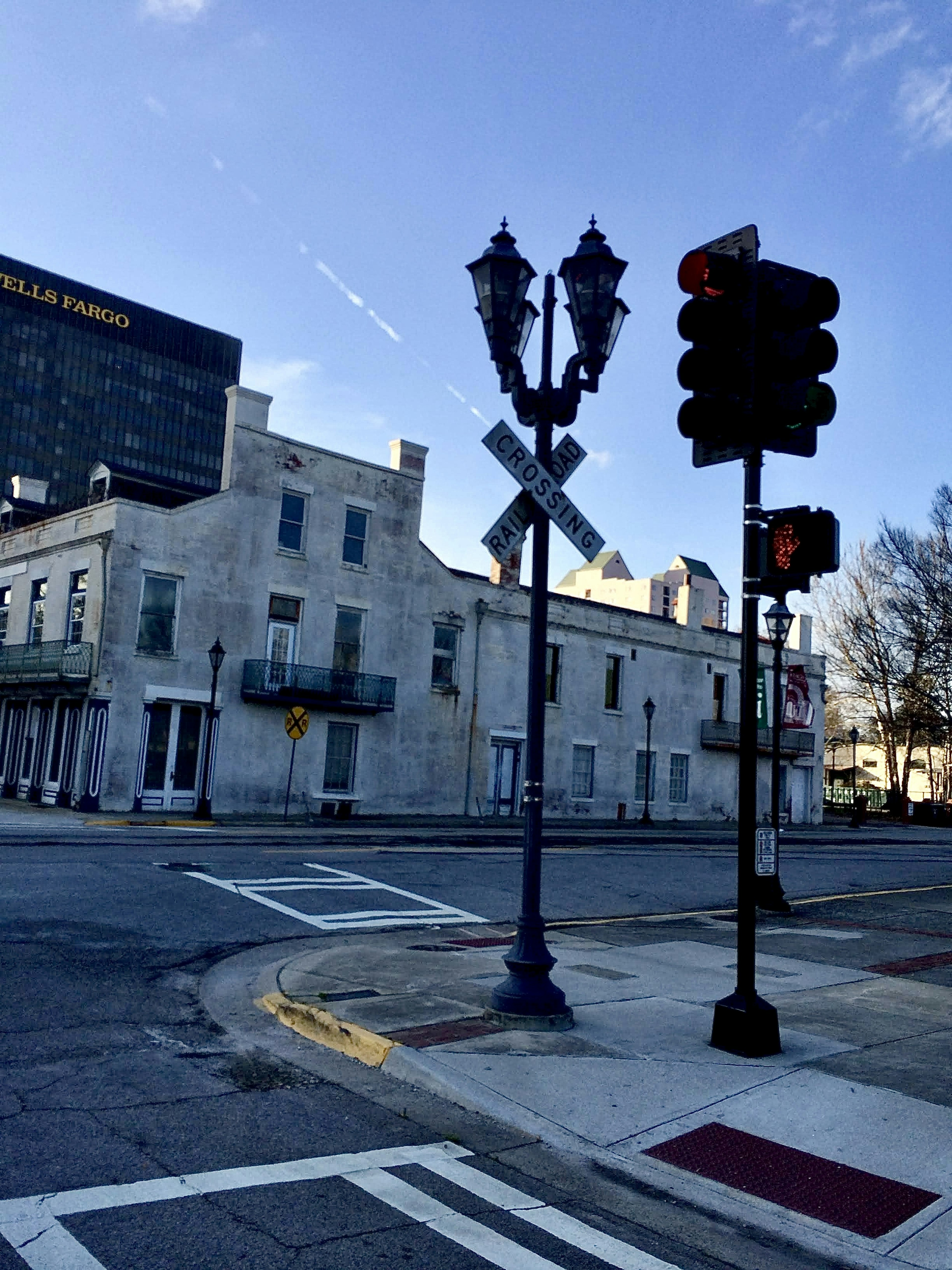 Intersection scene with white buildings and traffic signals