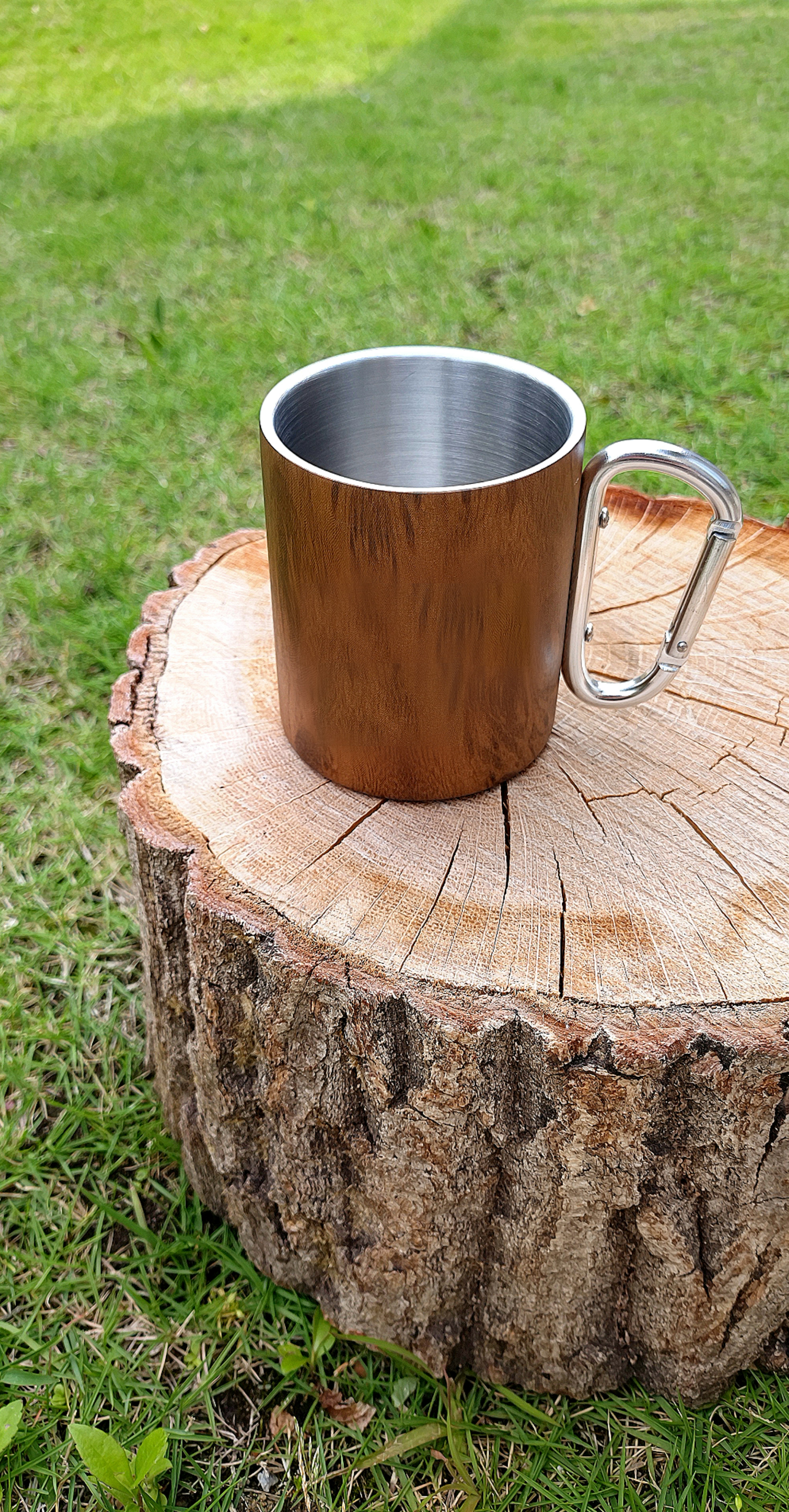 Metal mug placed on a wooden stump