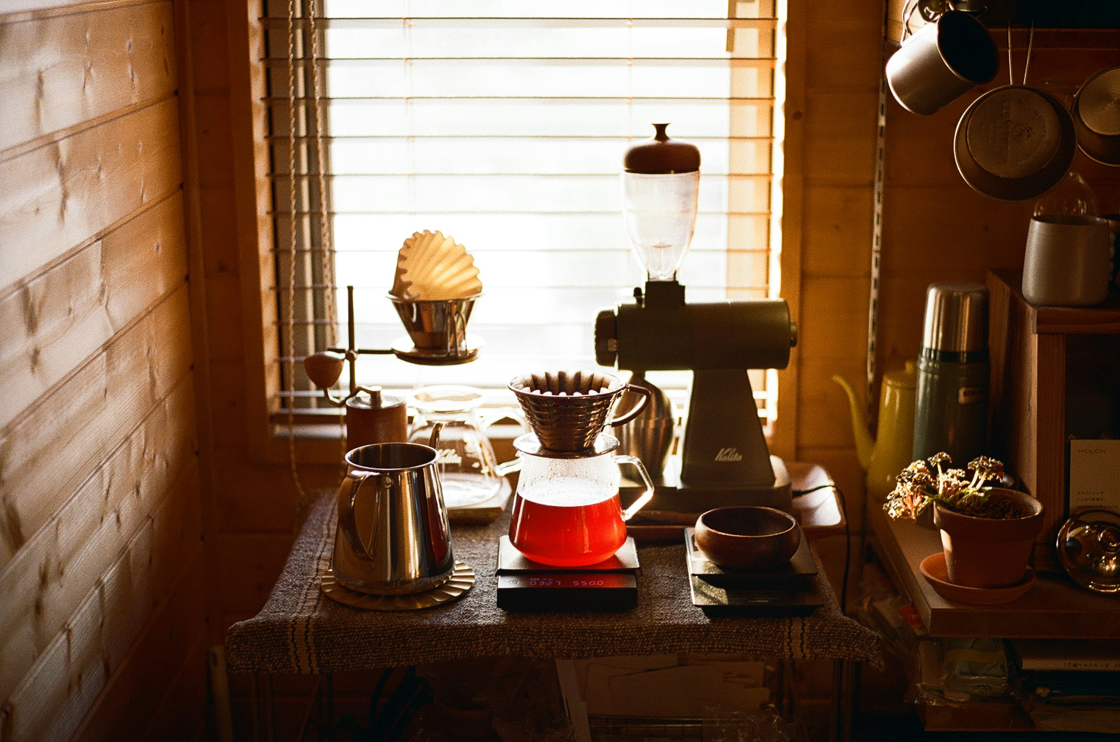 Cozy indoor scene with coffee equipment and accessories by a window