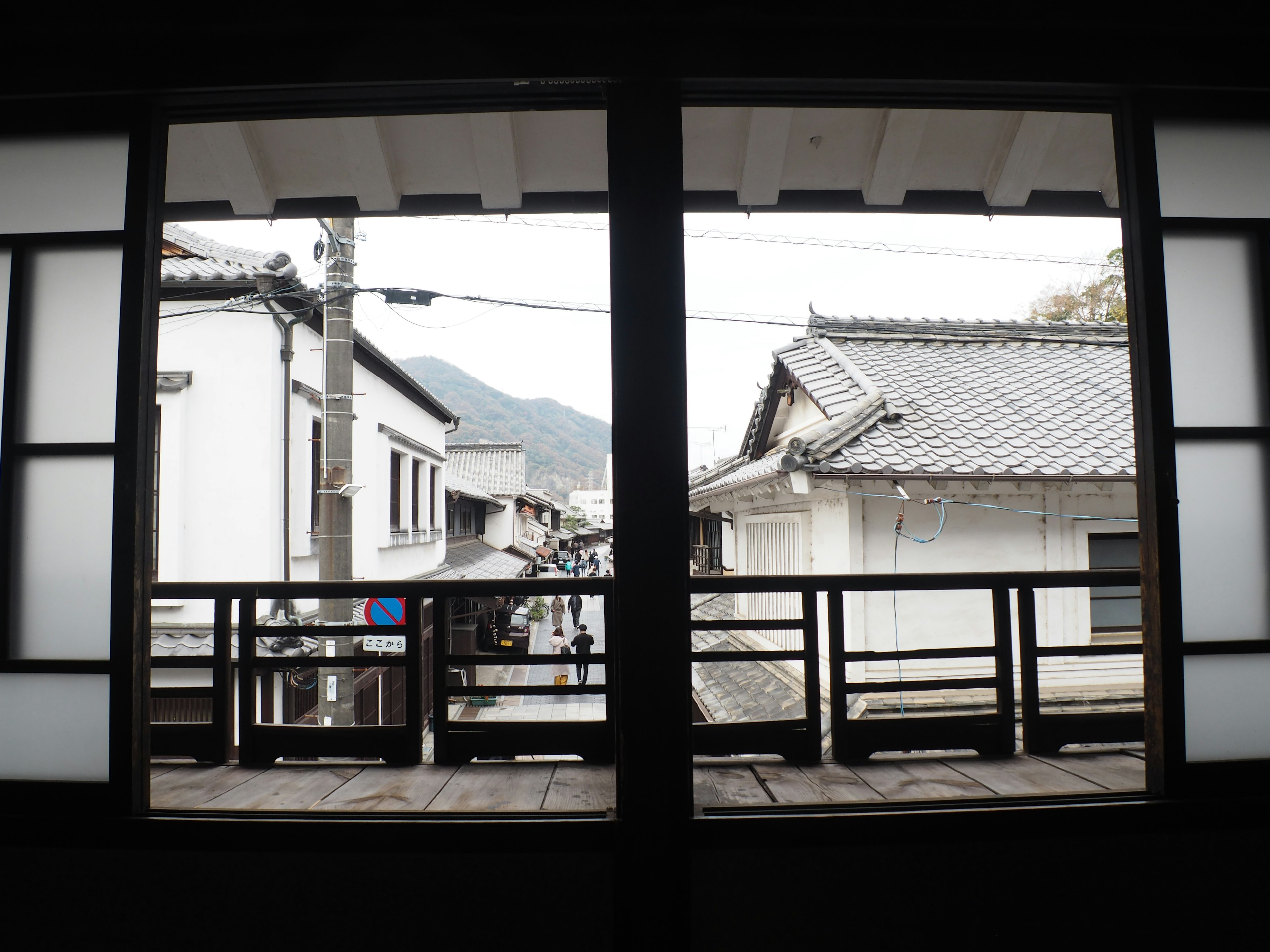 Blick auf traditionelle japanische Architektur und Berge durch ein Fenster