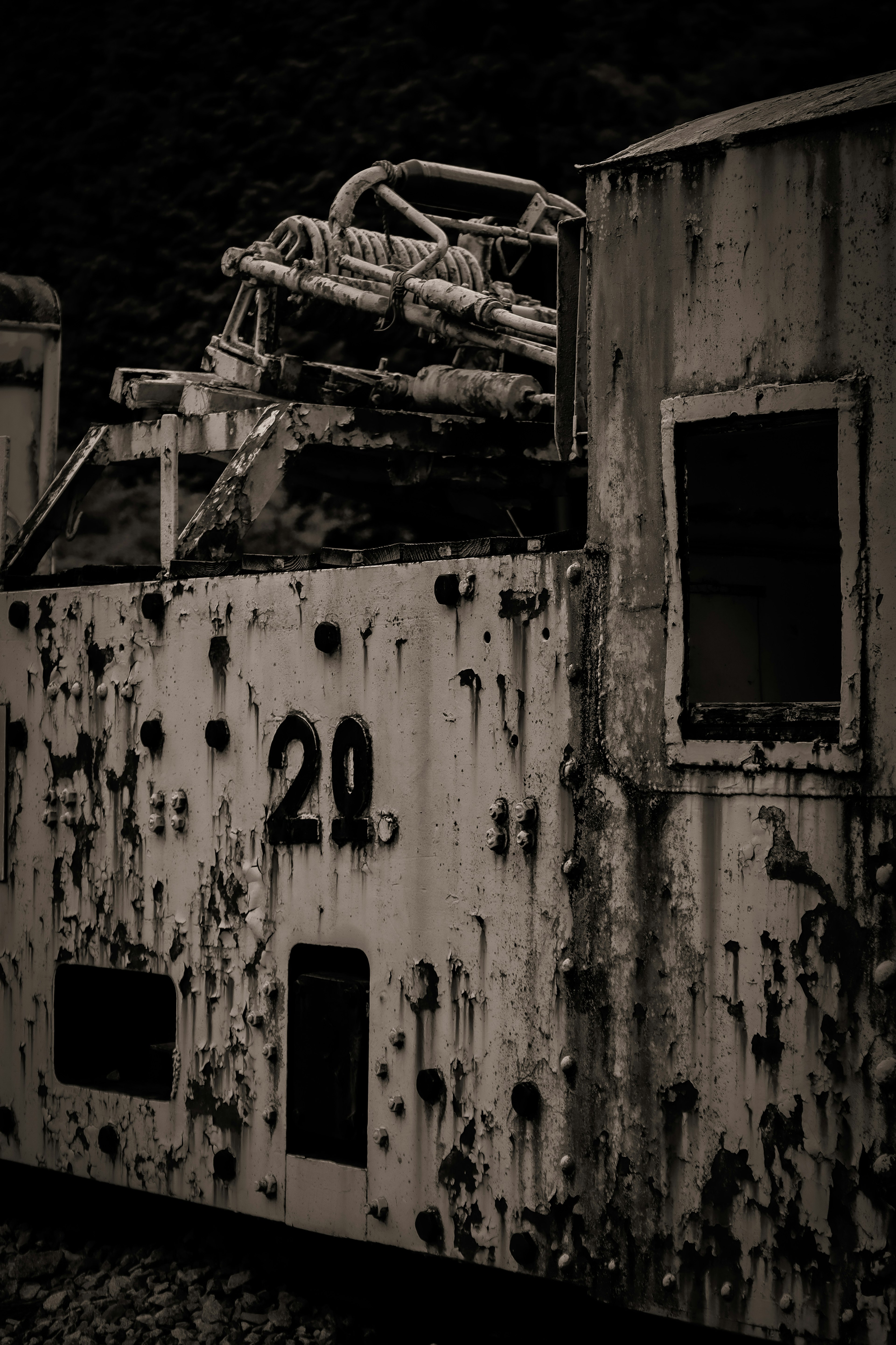 Close-up of an old train cab featuring a weathered surface and the number 22