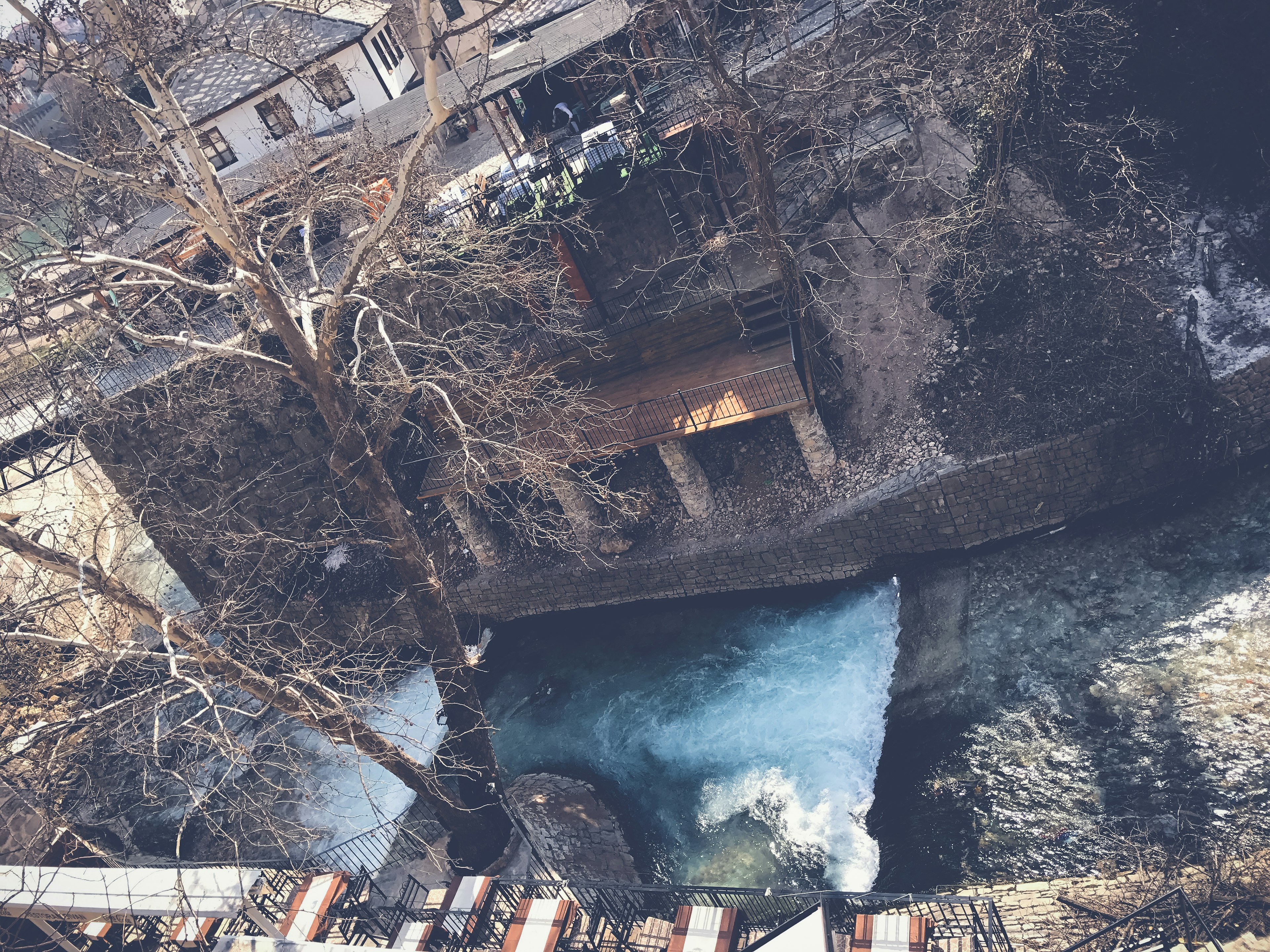 Aerial view of a river with trees and buildings