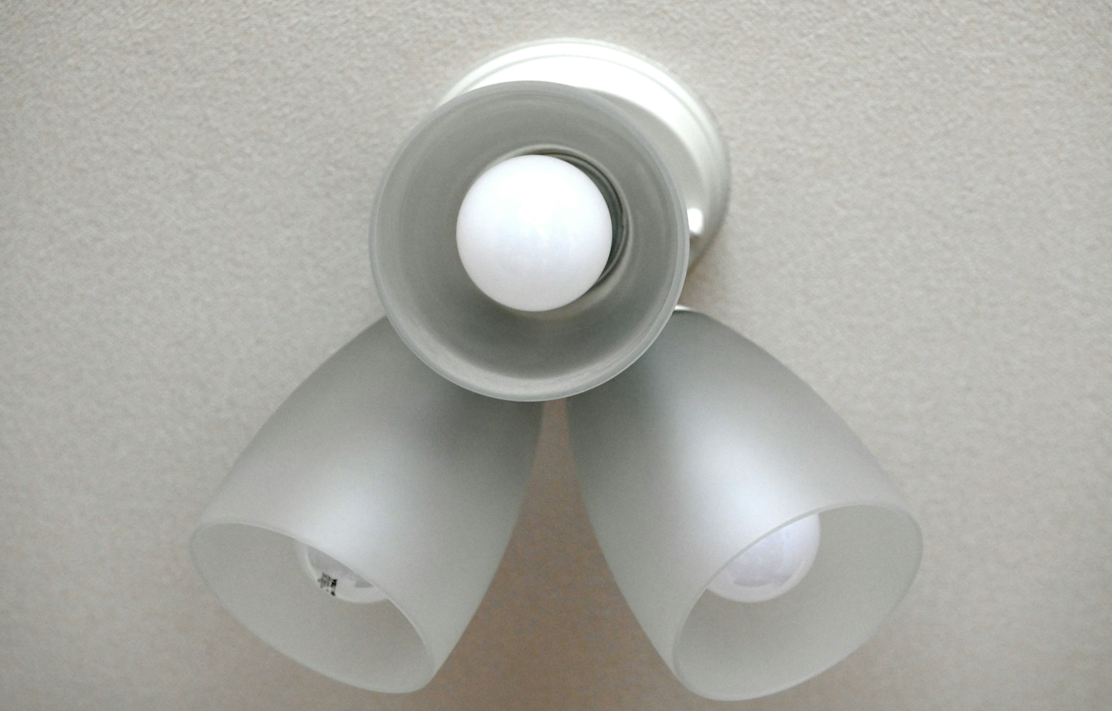 Ceiling-mounted light fixture with three frosted lamp shades