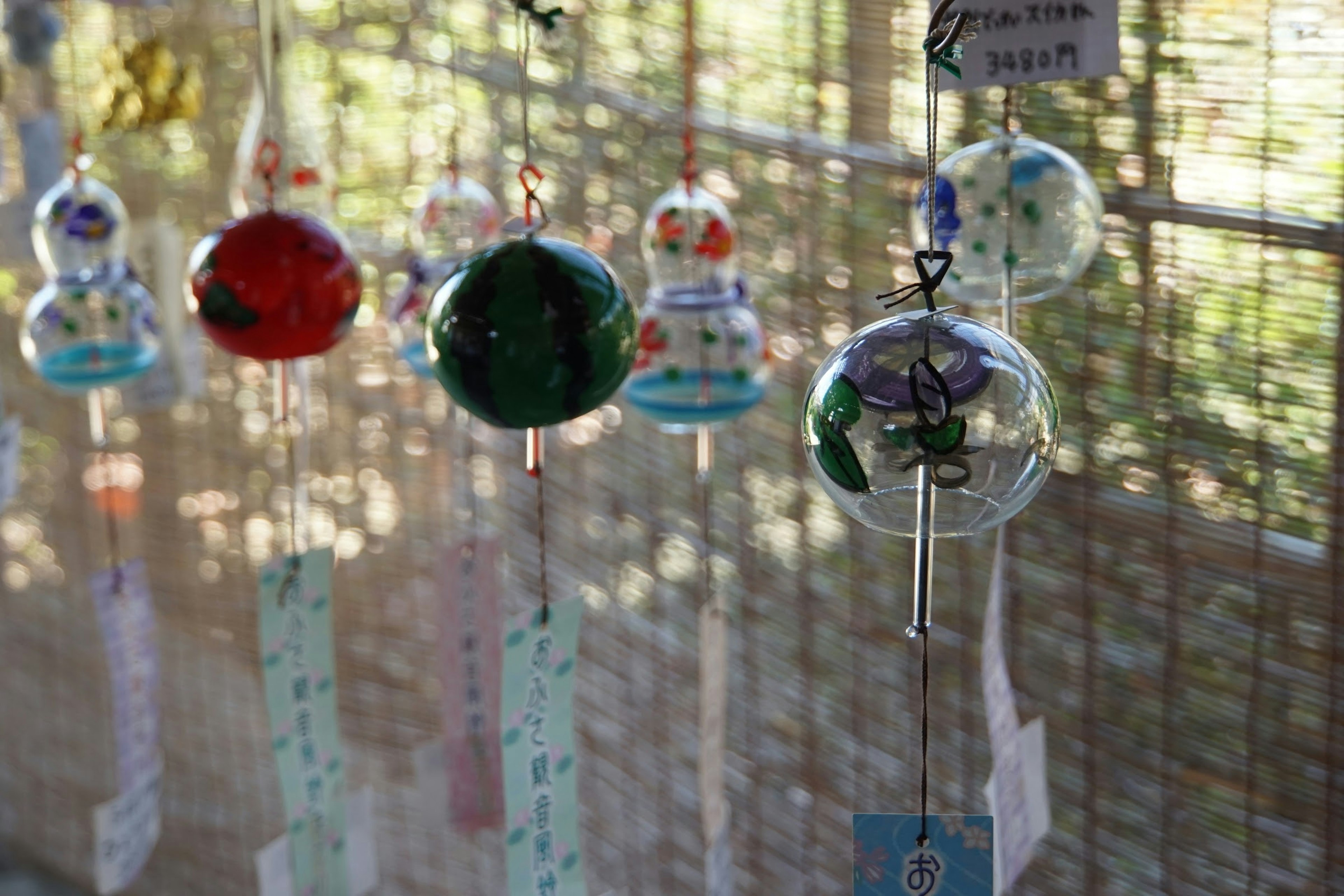 Colorful wind chimes hanging in a Japanese setting