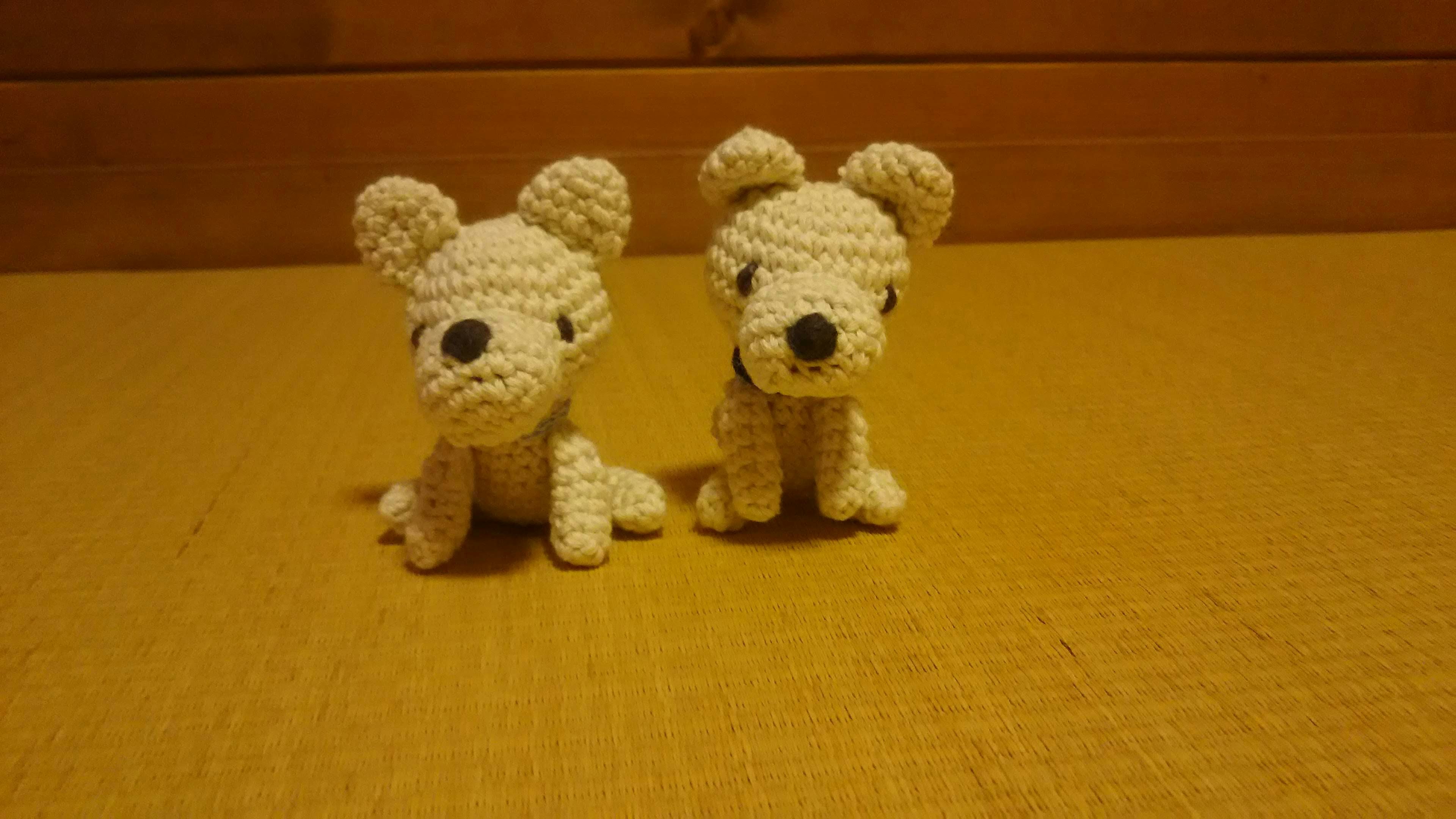 Two cute crocheted dogs sitting side by side