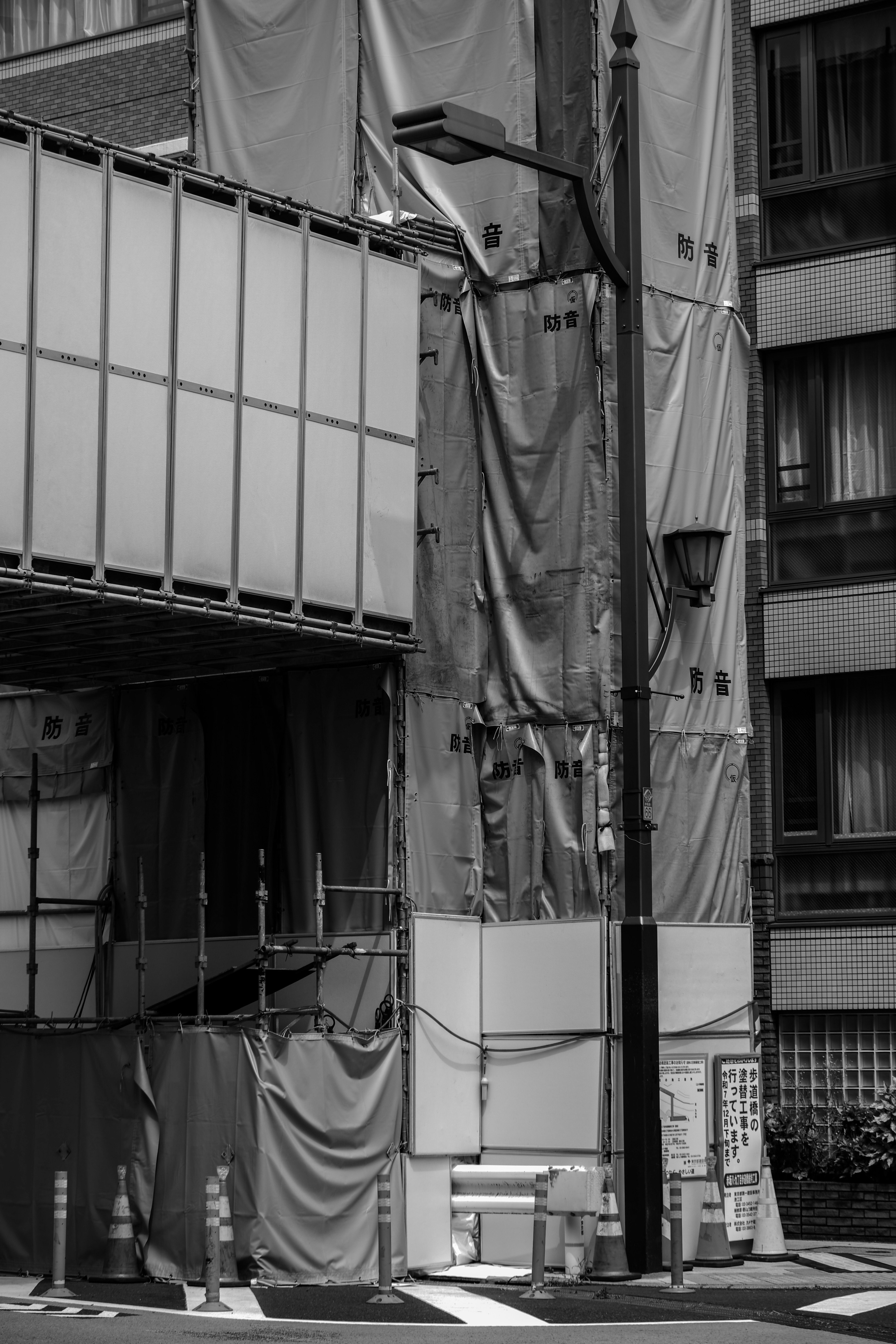 Black and white image of a building under construction with scaffolding