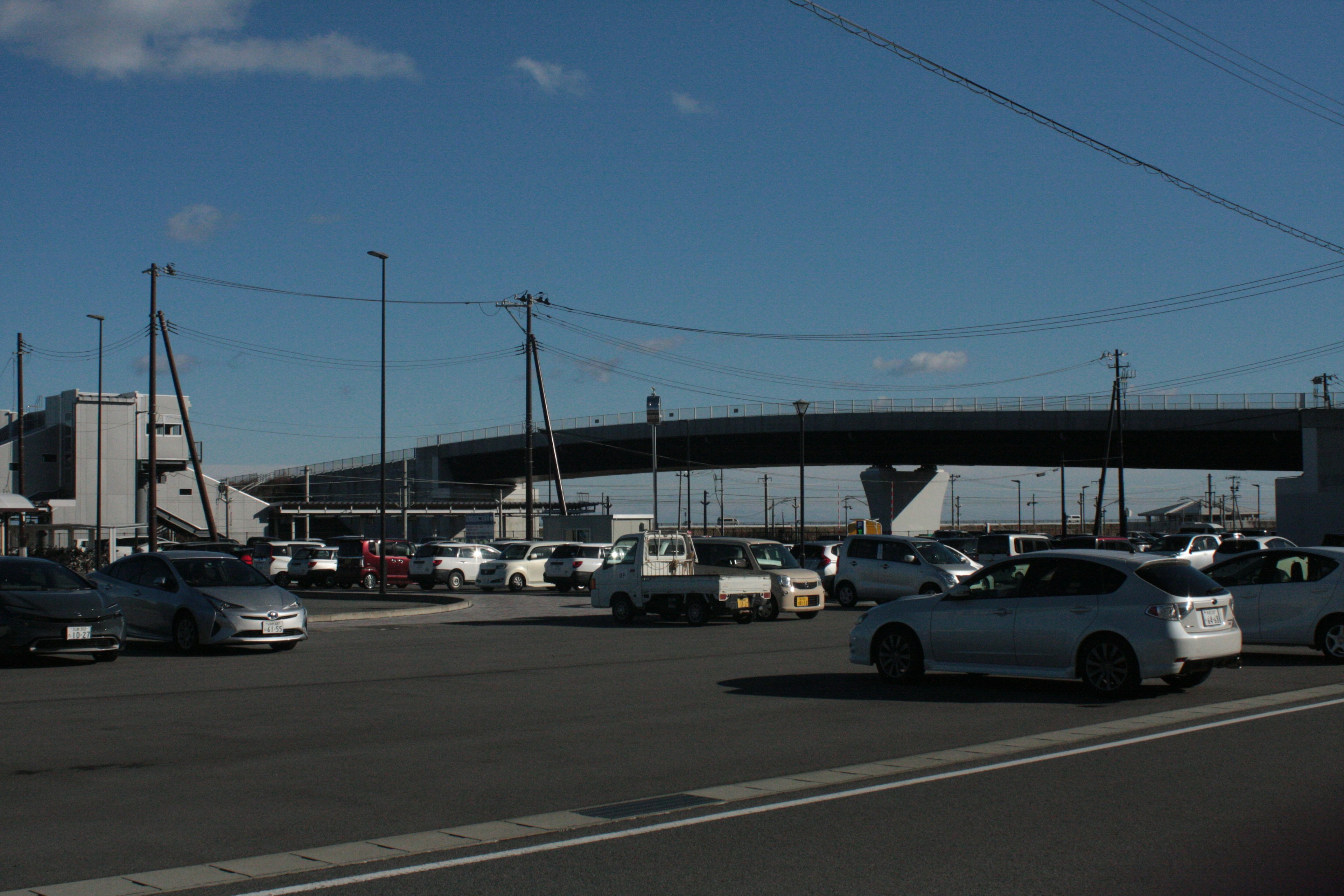 View of a large parking lot with an elevated road