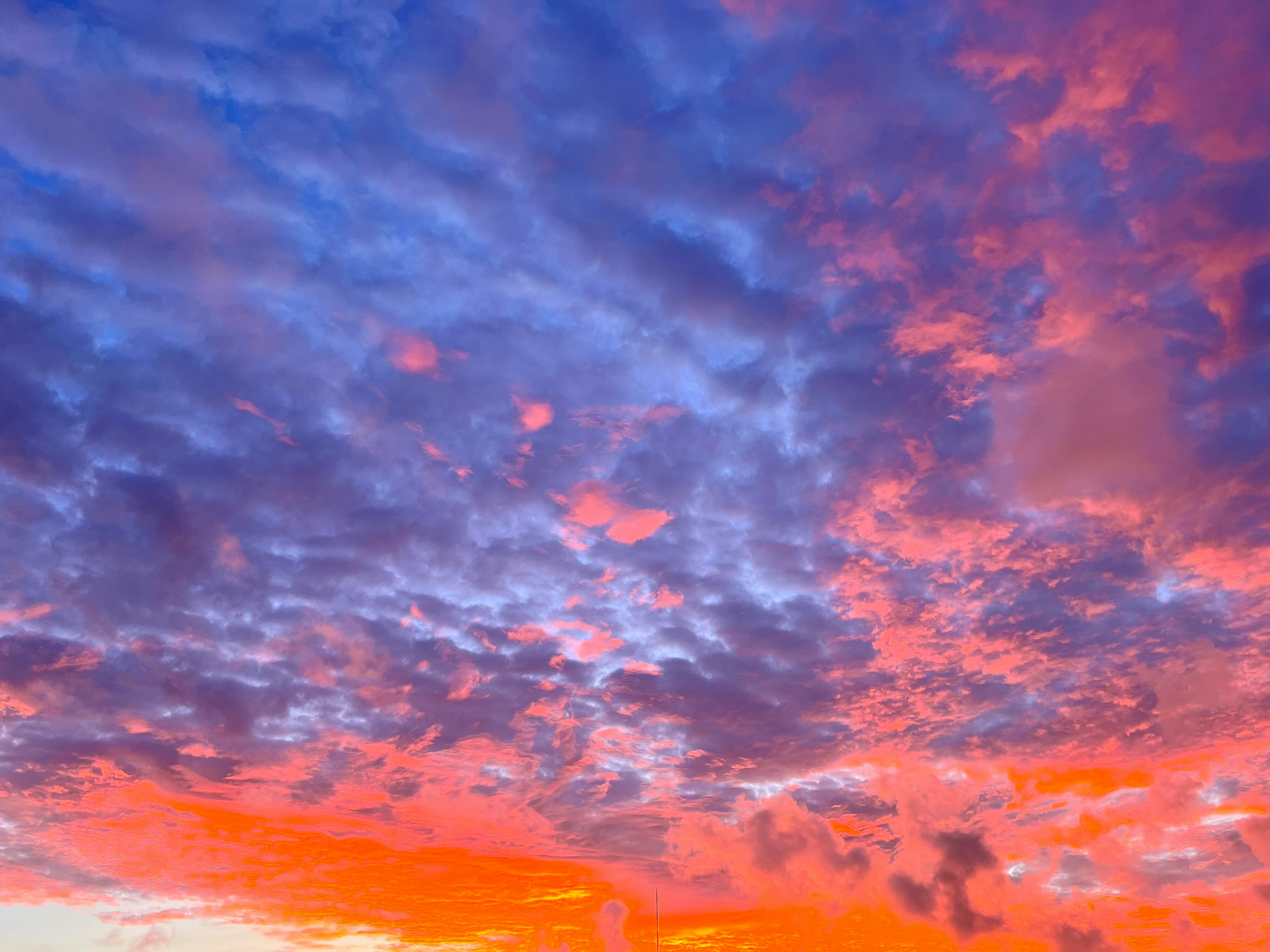 Stunning sunset sky with blue and orange gradients and scattered clouds