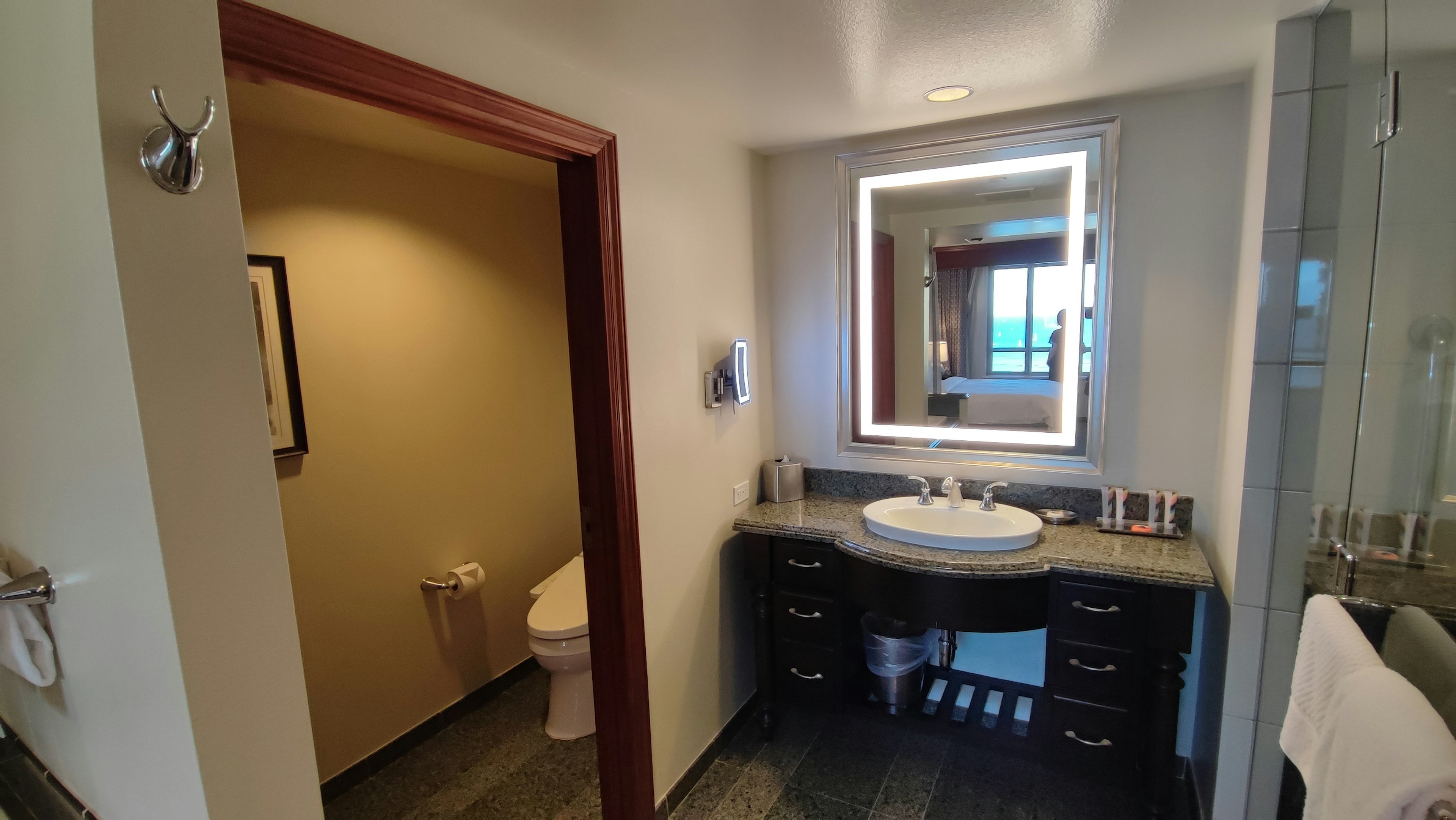 Bright bathroom interior featuring a simple vanity and mirror